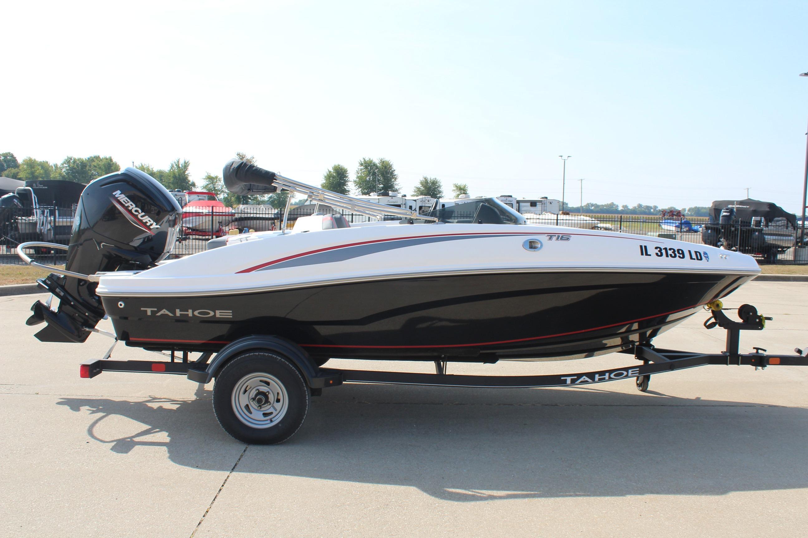 2023 Tahoe T16 boat on trailer with Mercury outboard motor, parked outdoors.