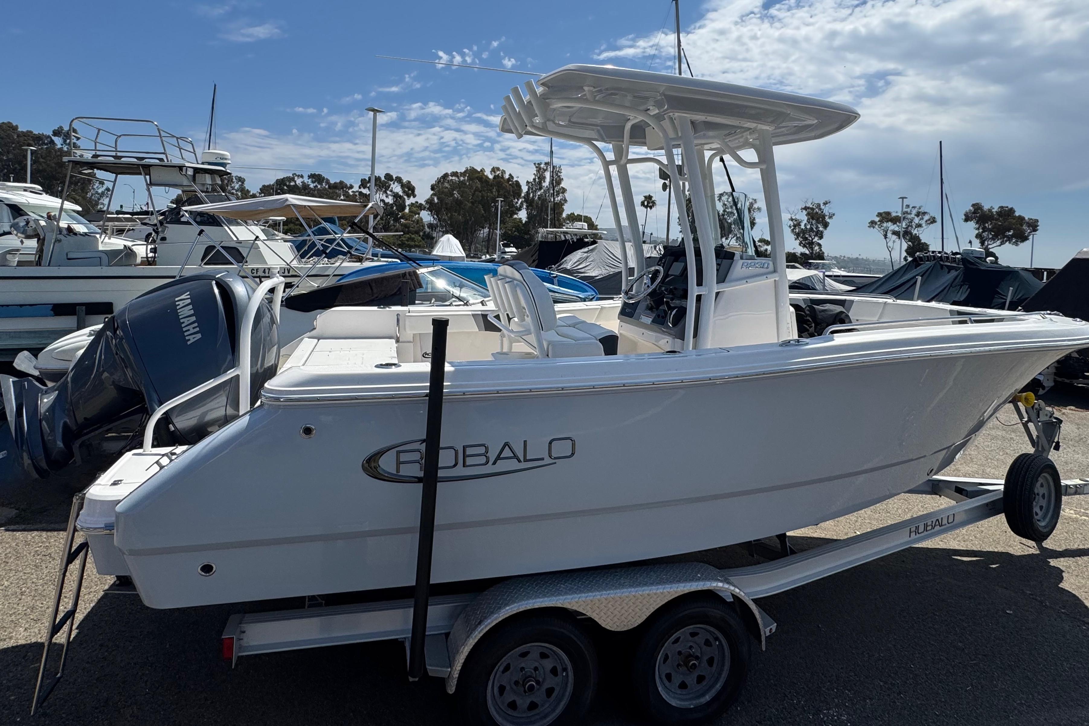 2022 Robalo R230 Center Console boat on trailer, parked at marina.