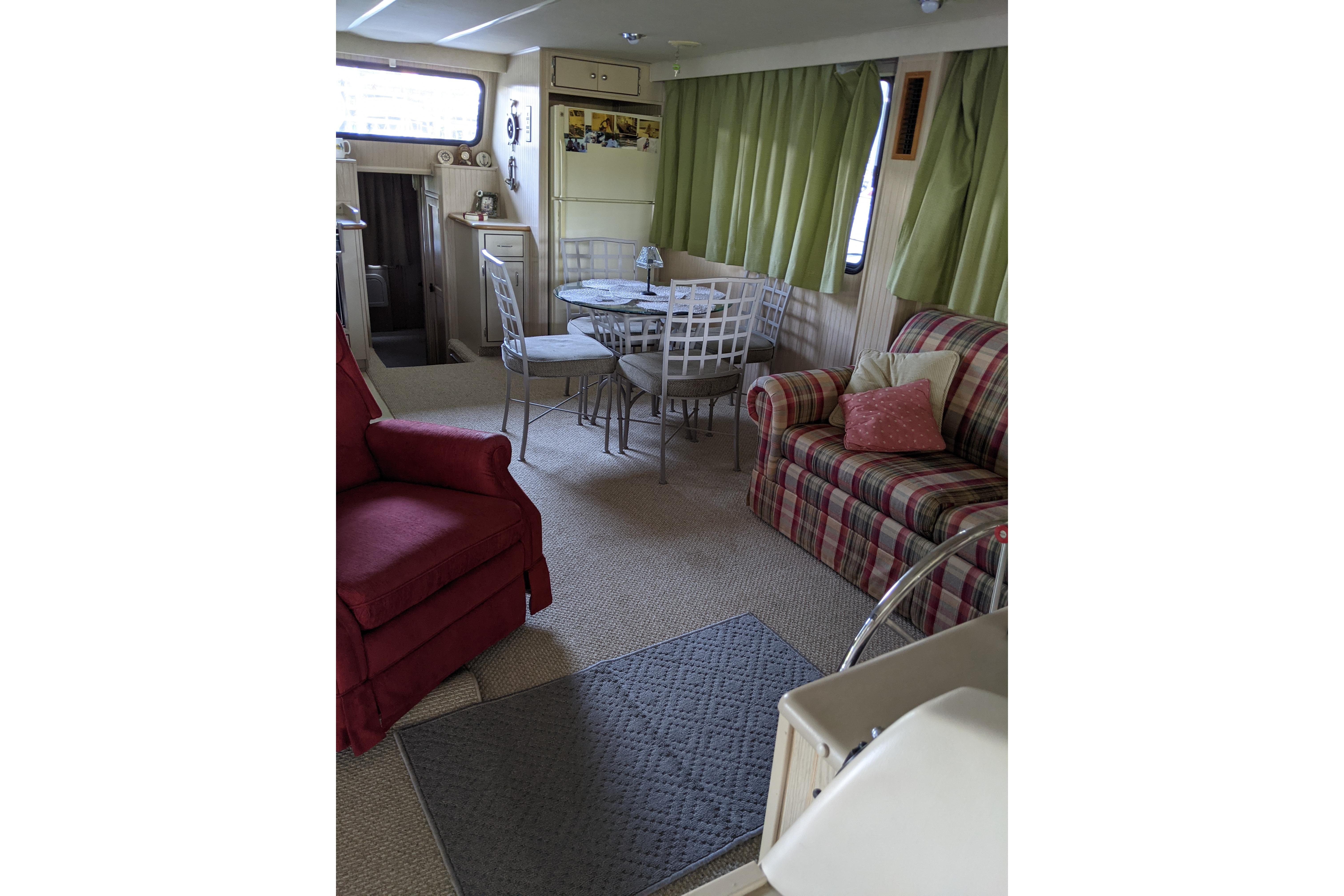 Interior of 2001 Gibson 50 Cabin Yacht with cozy seating and dining area.