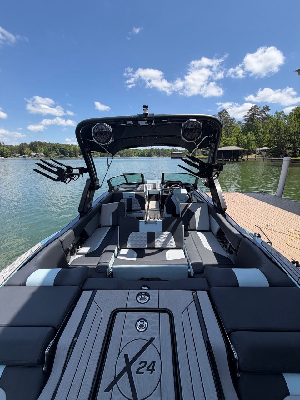 2023 MasterCraft X24 boat at lakeside, modern design.