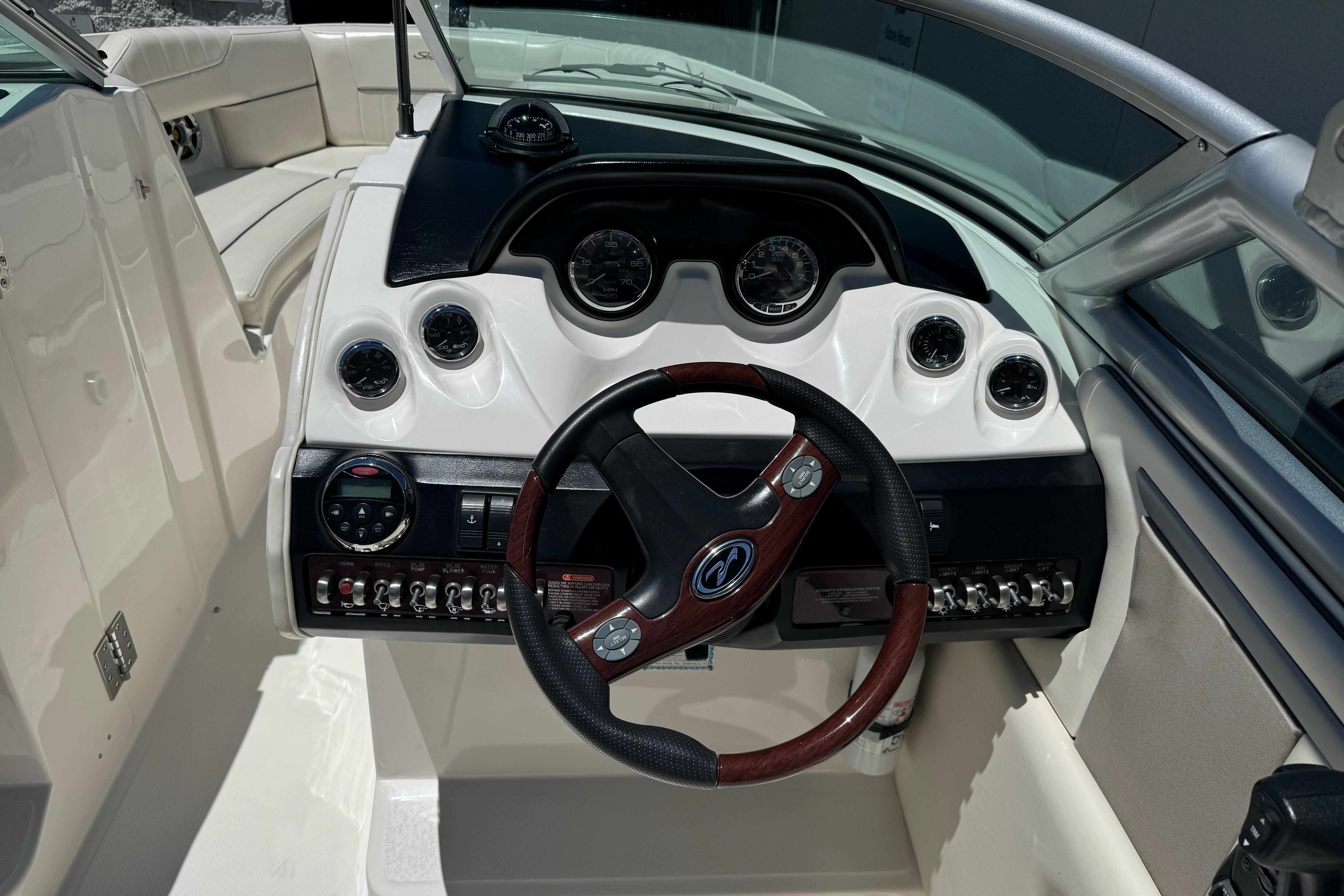 2007 Sea Ray SLX 250 boat dashboard with steering wheel and instrument panel.