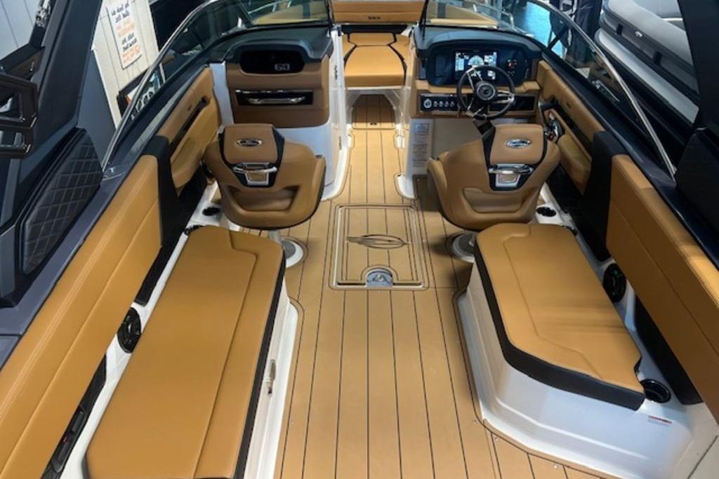 Interior of 2025 Chaparral 2870 SSX boat with tan seating and modern dashboard.