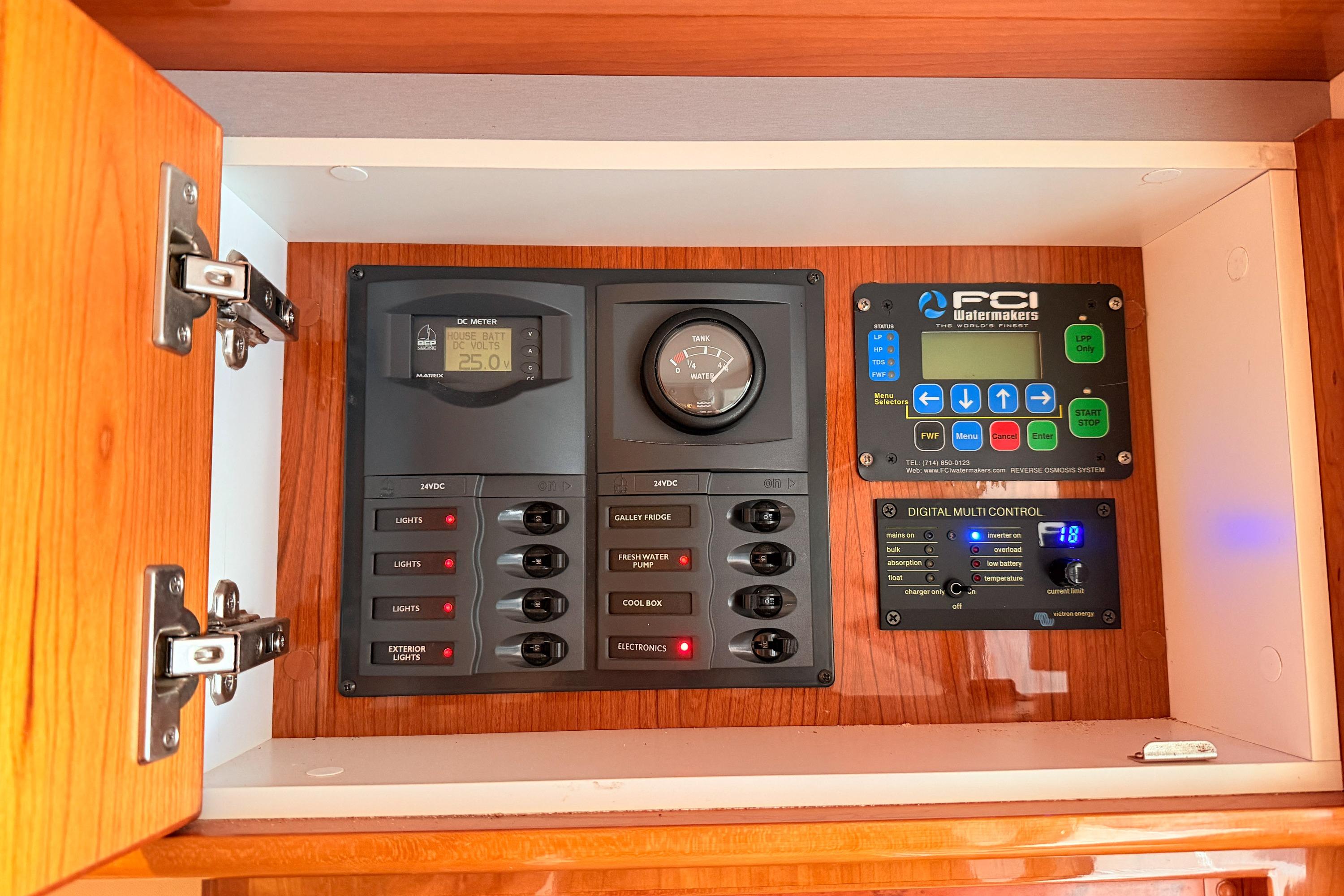 Control panel inside 2011 Riviera 5000 Sport Yacht, featuring digital meters and switches.
