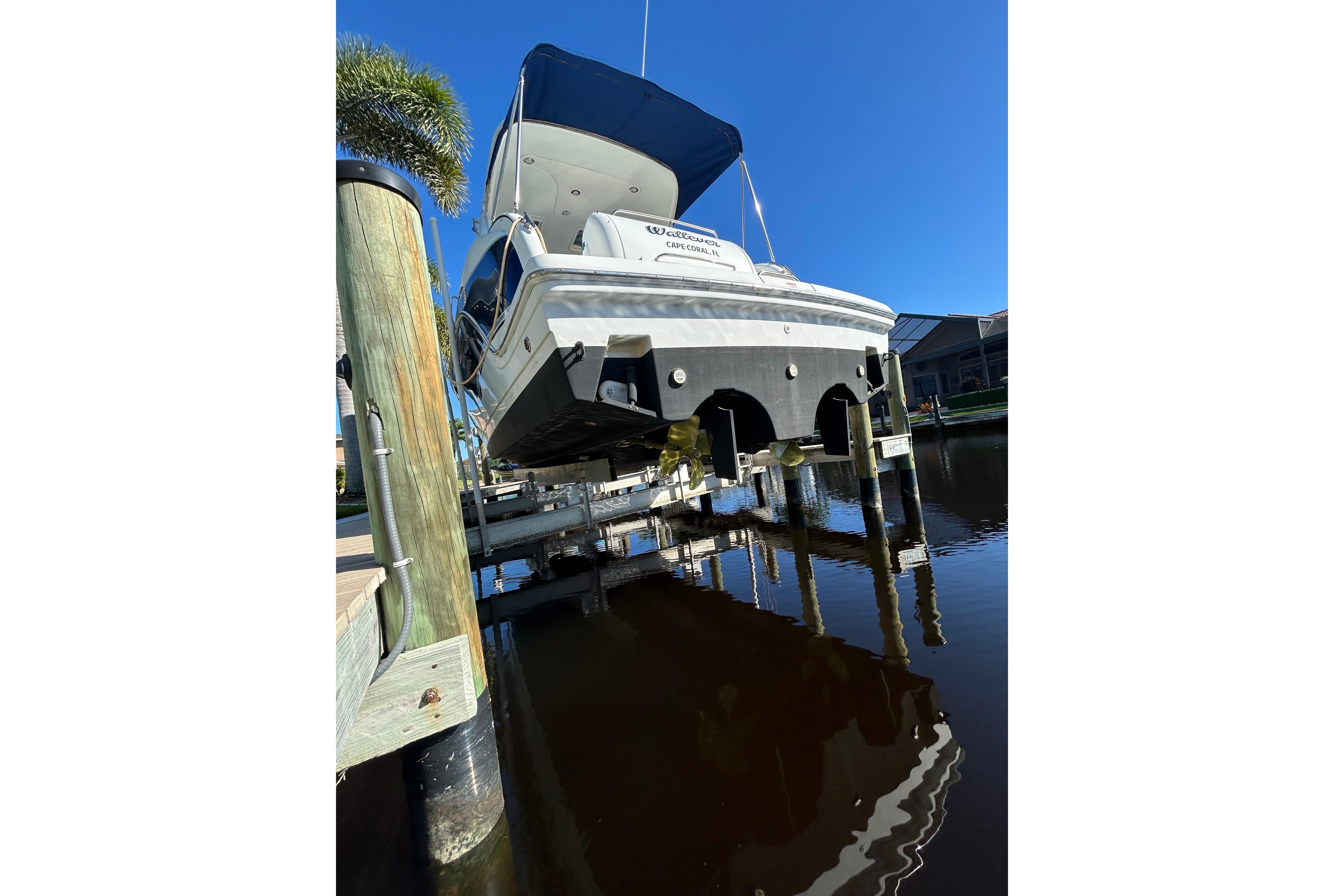 2008 Formula 34 Performance Cruiser docked, rear view, sunny day, calm water.