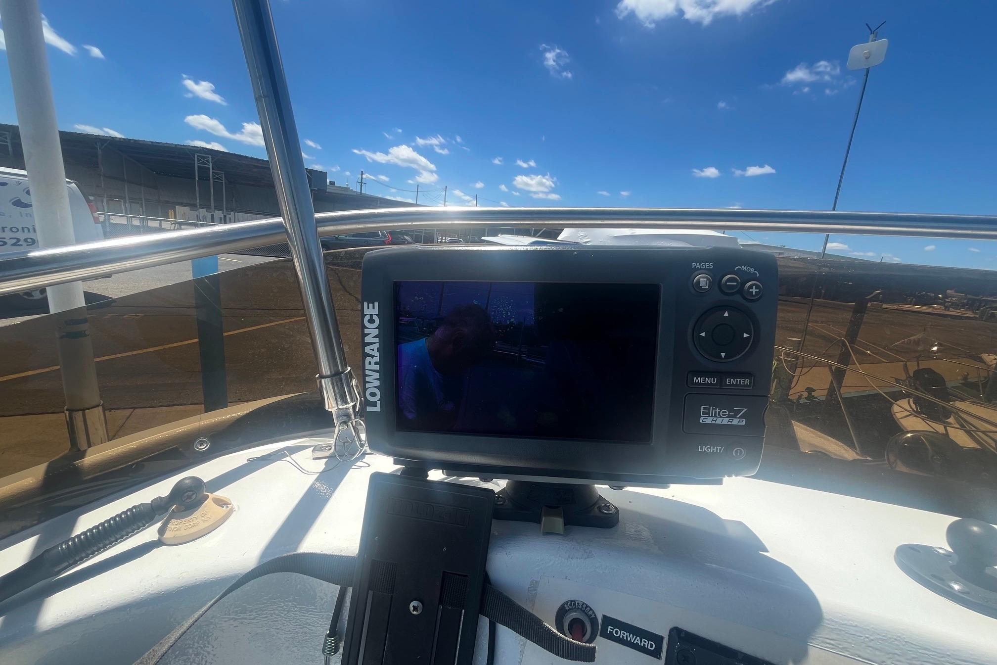 Lowrance Elite-7 GPS on 1988 Seafox 29 Flybridge boat under clear blue sky.
