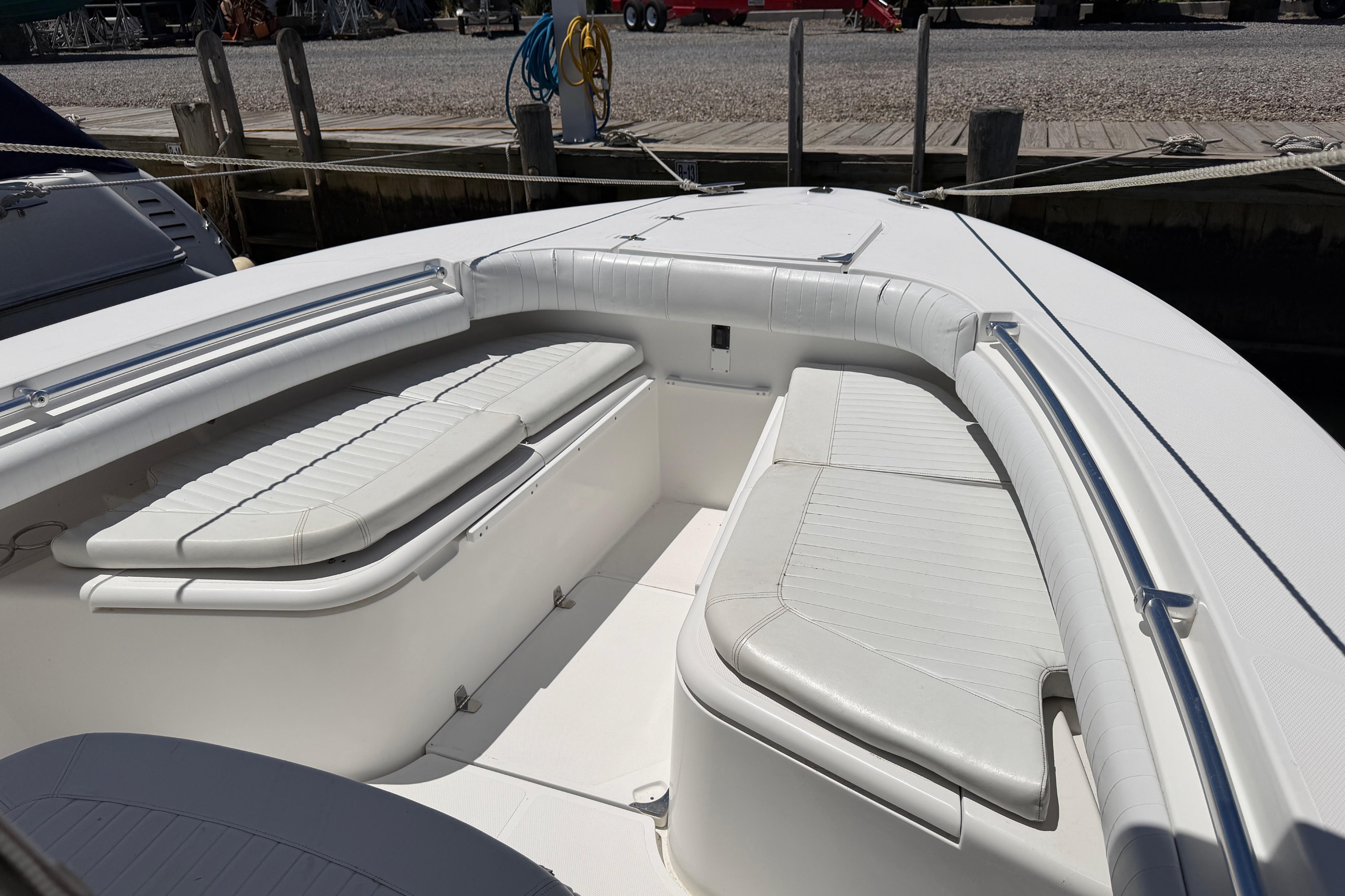 2006 Southport 26 Center Console boat with white cushioned seating and sleek design.