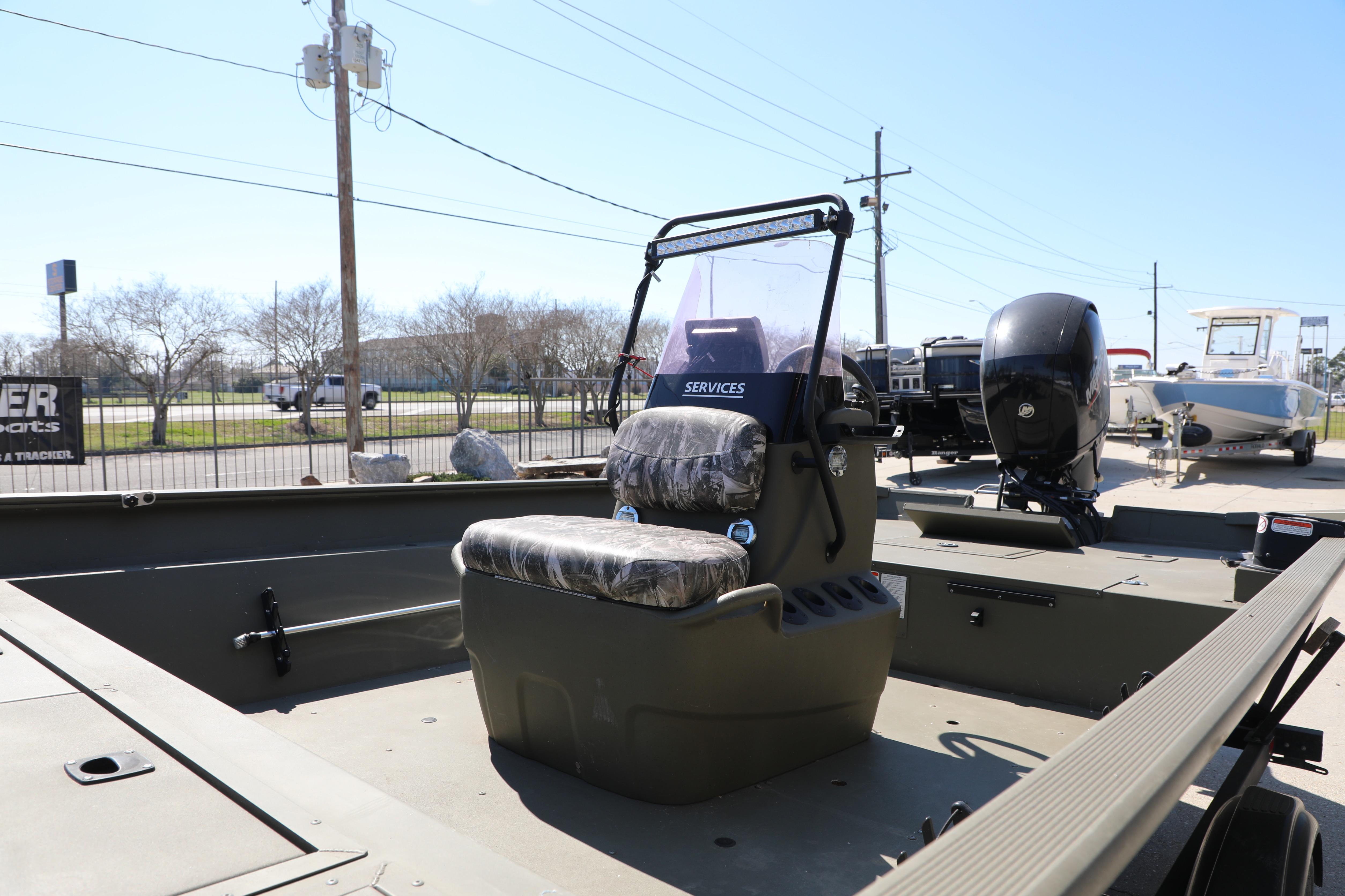 2021 Tracker Grizzly 2072 SC All-Welded boat with camo seating and outboard motor.