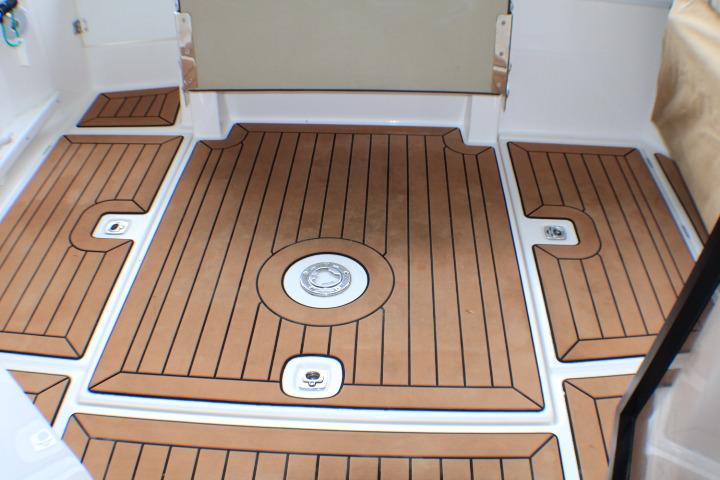 2020 Ranger Tugs R-27 boat deck with teak-style flooring and drainage features.