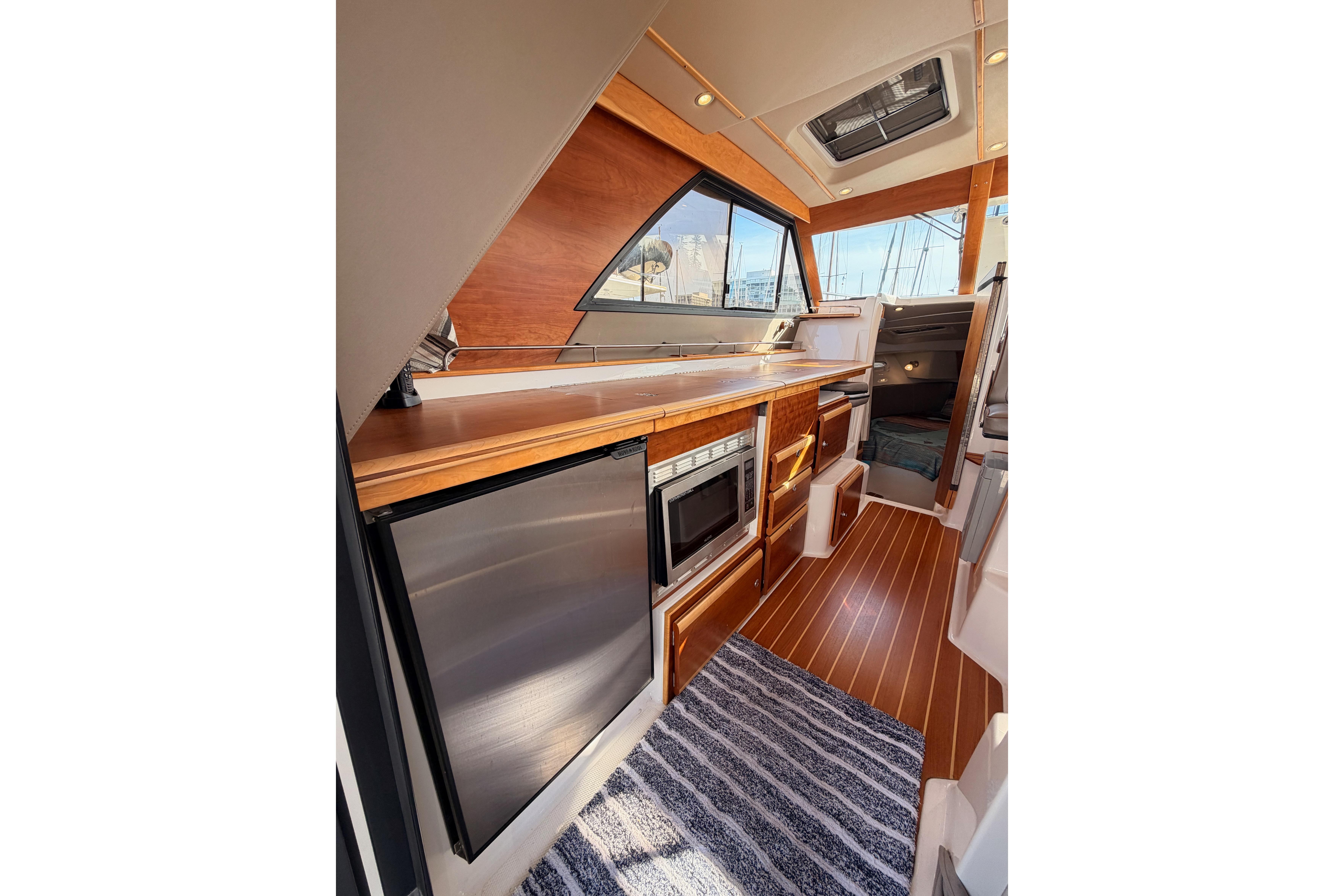Interior of 2021 Cutwater C-32 CB boat with modern kitchen and wood accents.