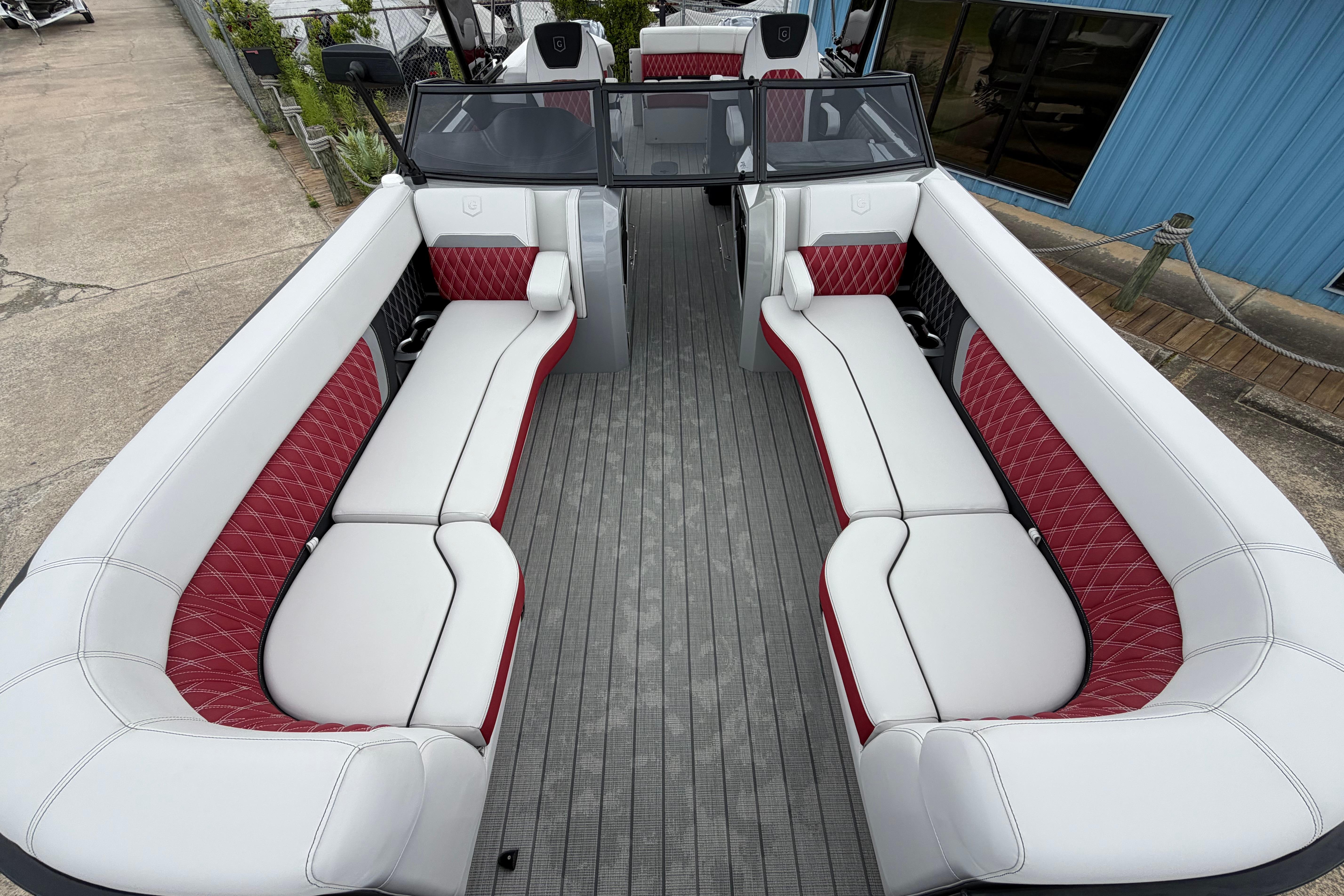 2023 Godfrey Sanpan 2700 ULW Twin pontoon boat with luxurious white and red seating.