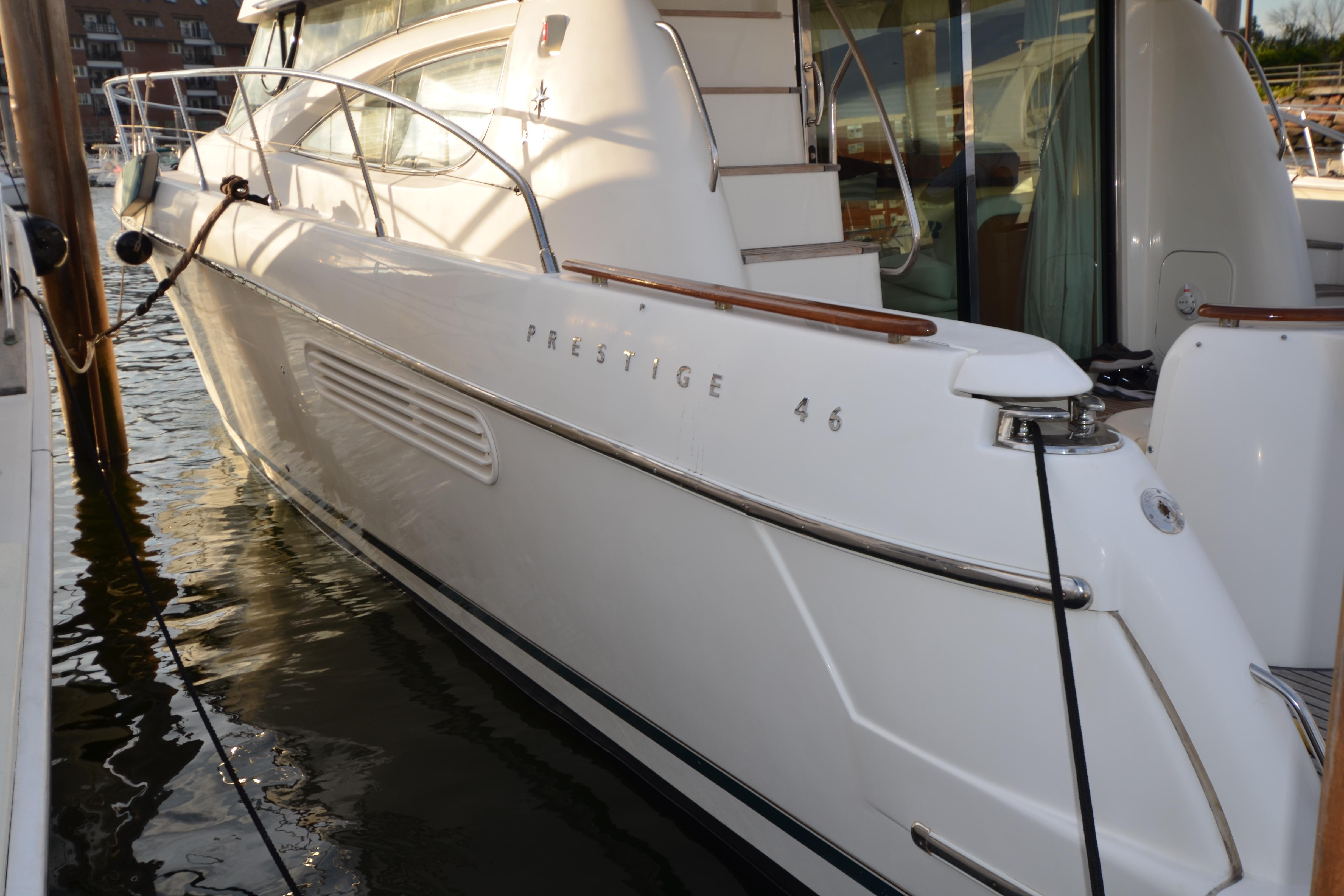 2007 Jeanneau Prestige 46 yacht docked at marina, side view.