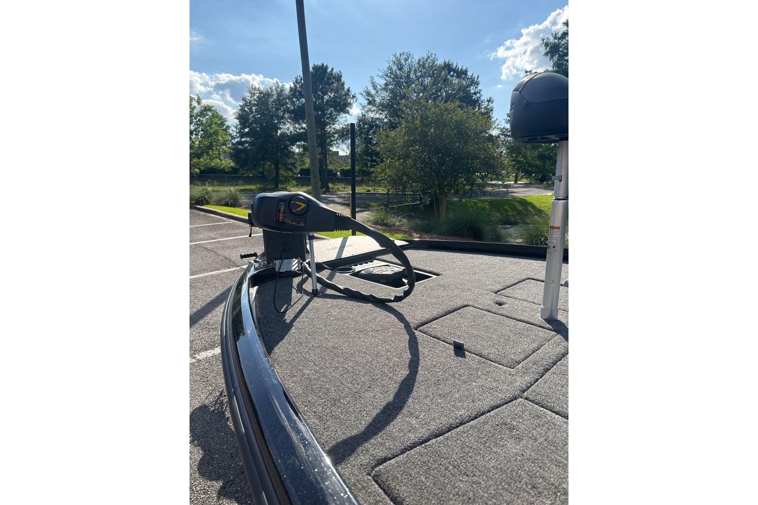 2026 Nitro Z21 XL boat deck with trolling motor, parked under sunny skies.