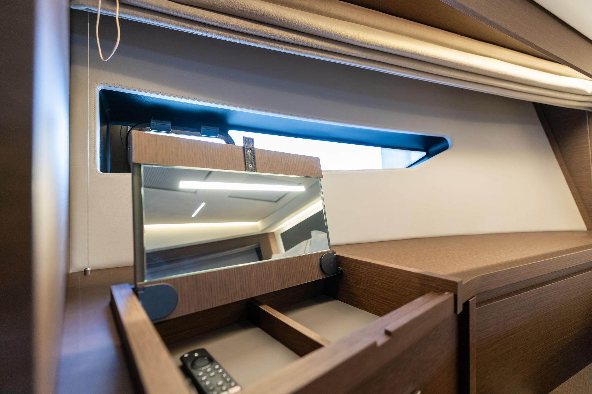 Interior of 2022 Prestige 520 yacht with wooden cabinetry and mirror.