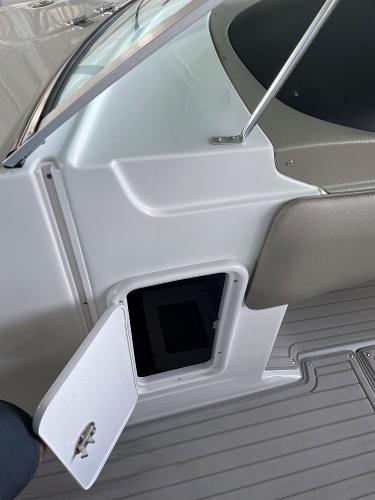 2019 Crownline E255 boat storage compartment with open hatch on deck.