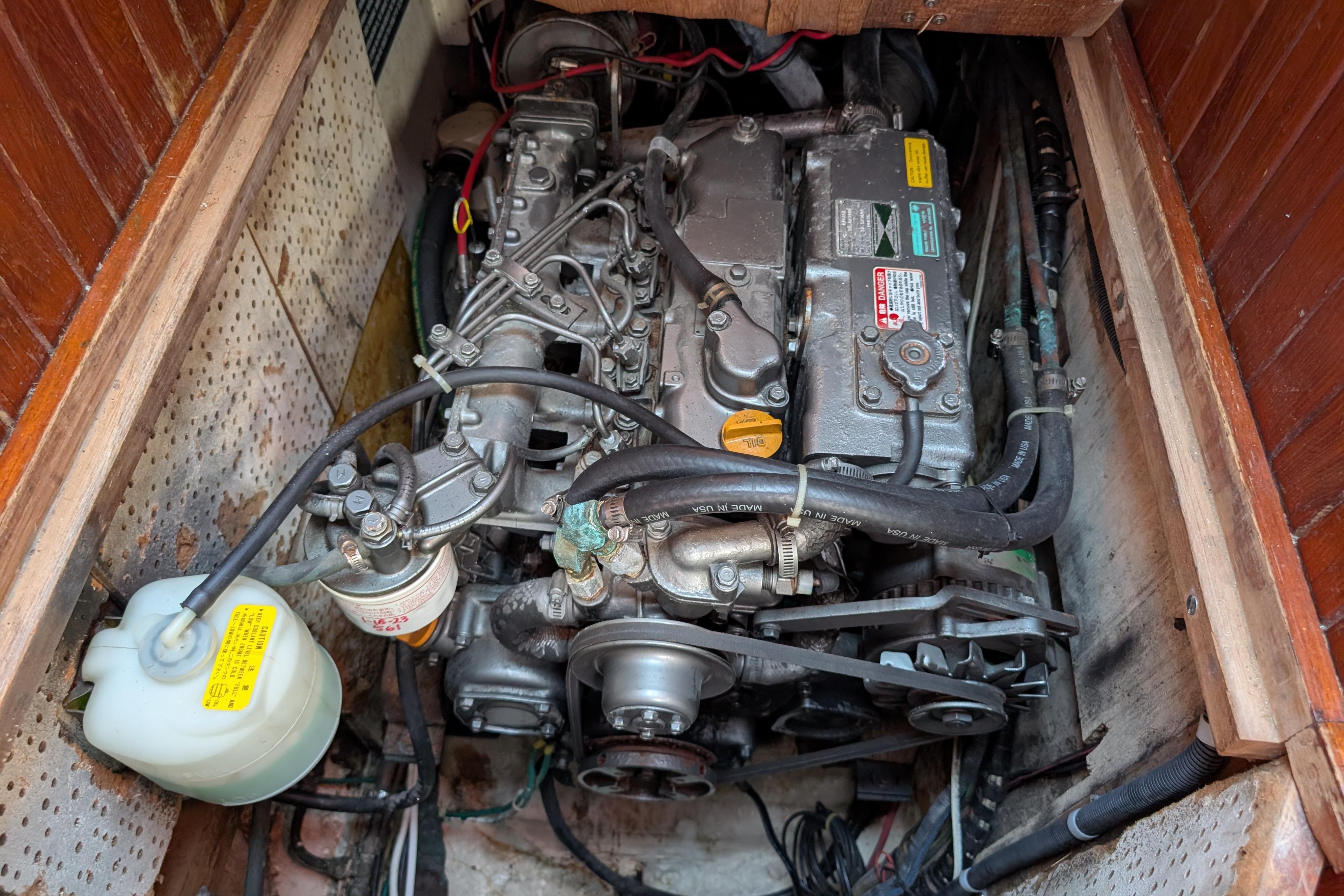 Engine compartment of a 1983 Robert Perry 41 sailboat, showing detailed mechanical components.