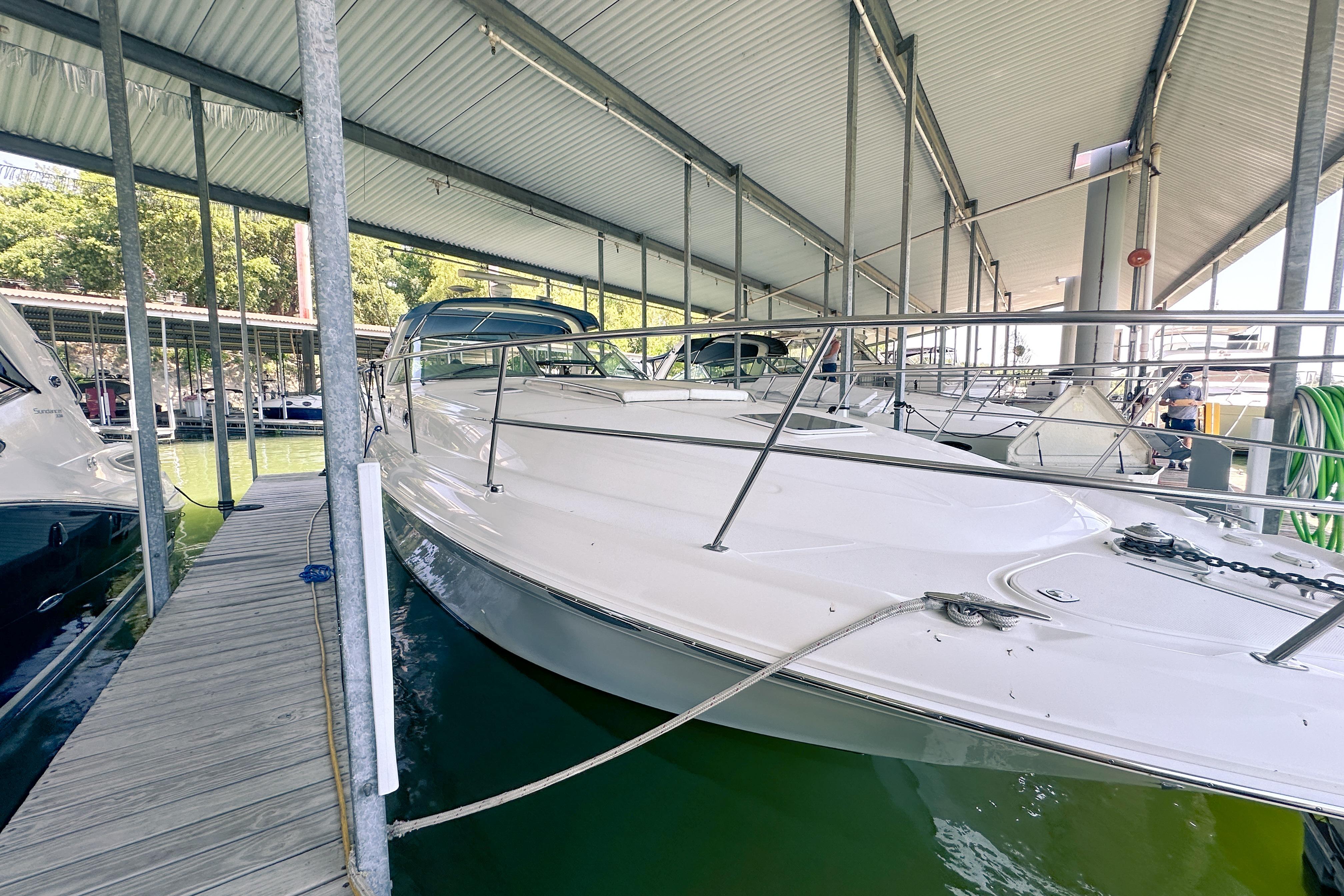 2001 Sea Ray 410 Sundancer yacht docked under a covered marina.