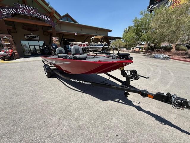 2025 Tracker Panfish 17 boat at service center, red color, on trailer.