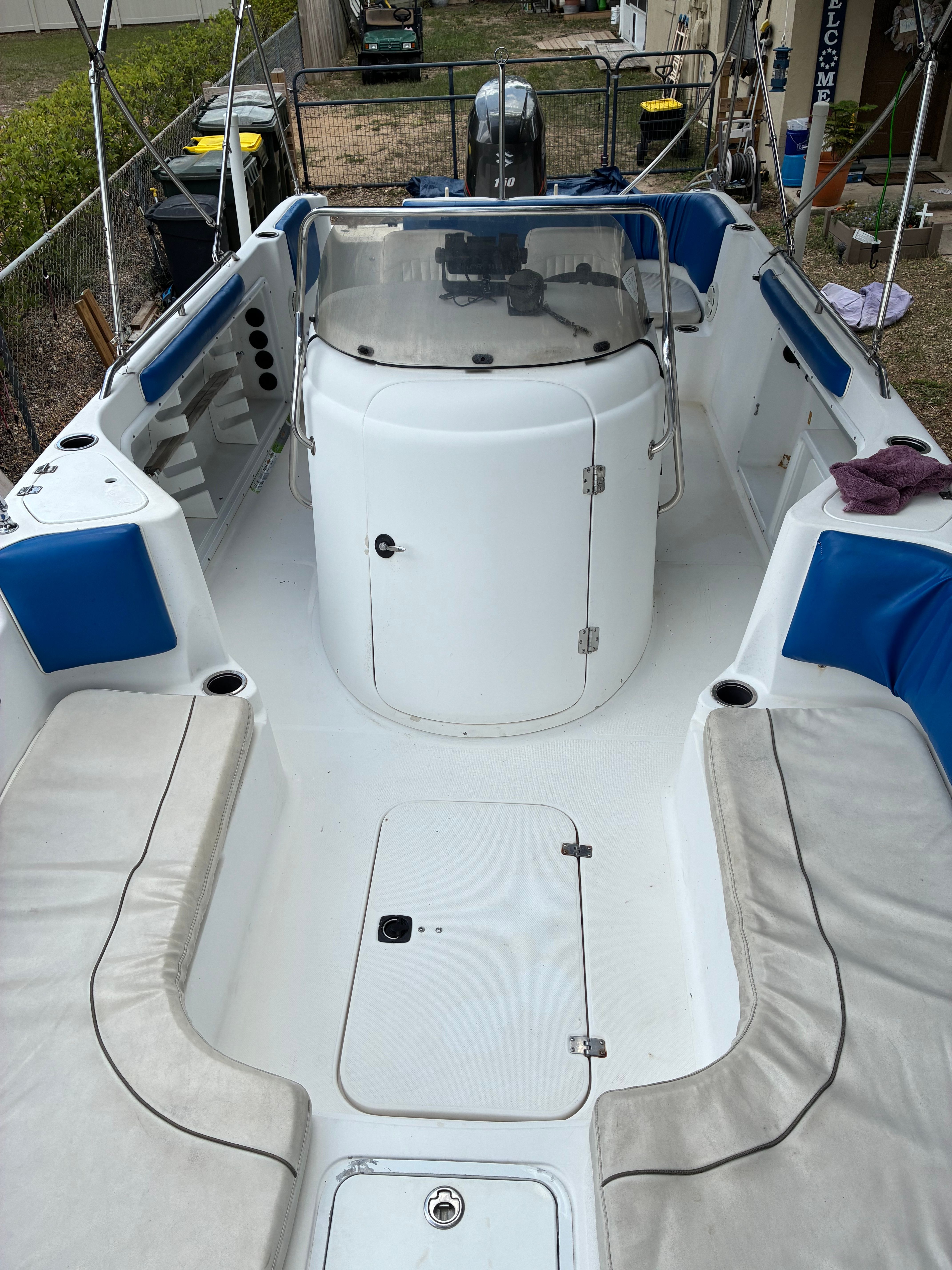 The image shows the cockpit of a 2012 Hurricane SunDeck Sport 231 OB with blue and white seating.