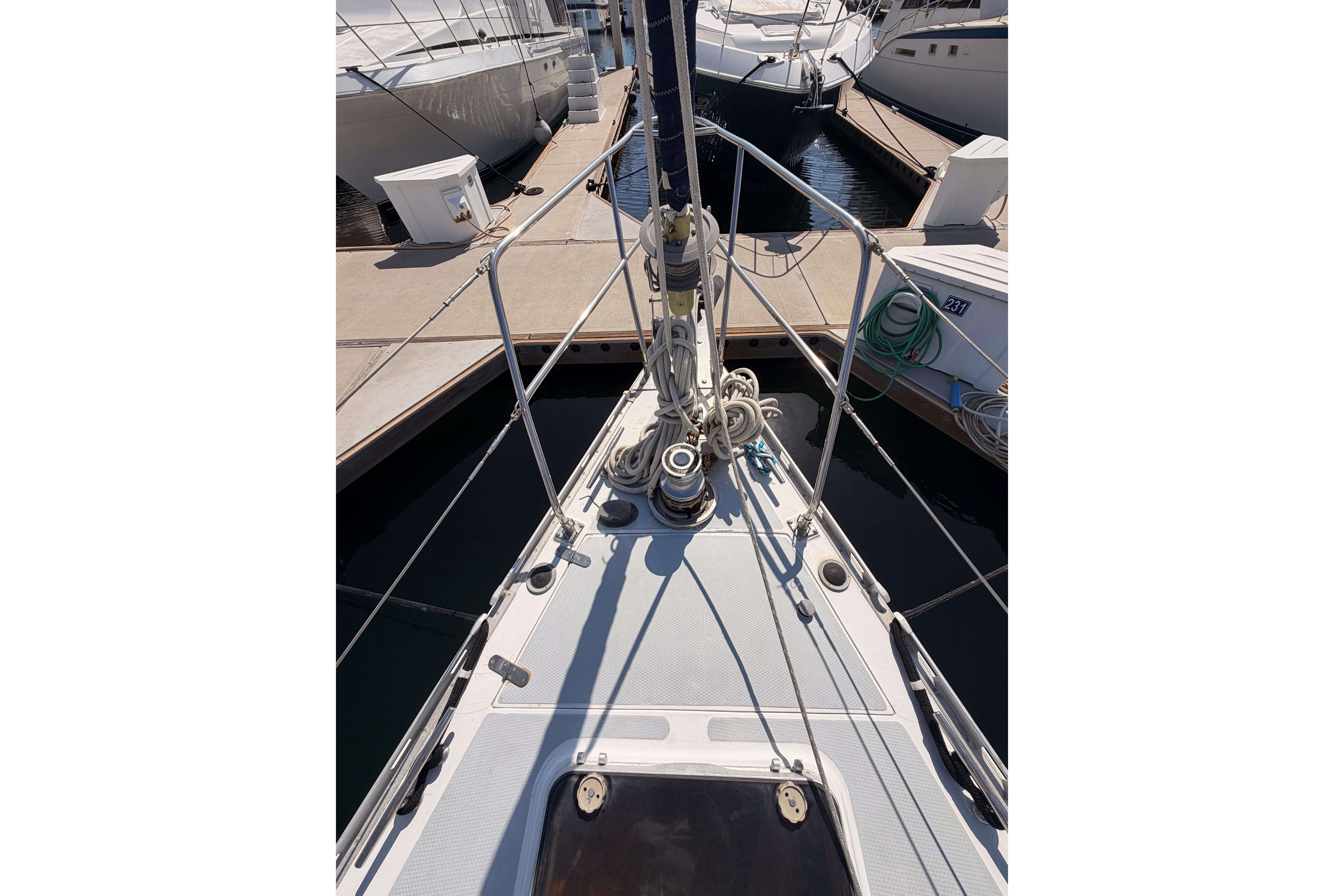 Bow view of a 1991 Hylas 51 yacht docked at a marina.
