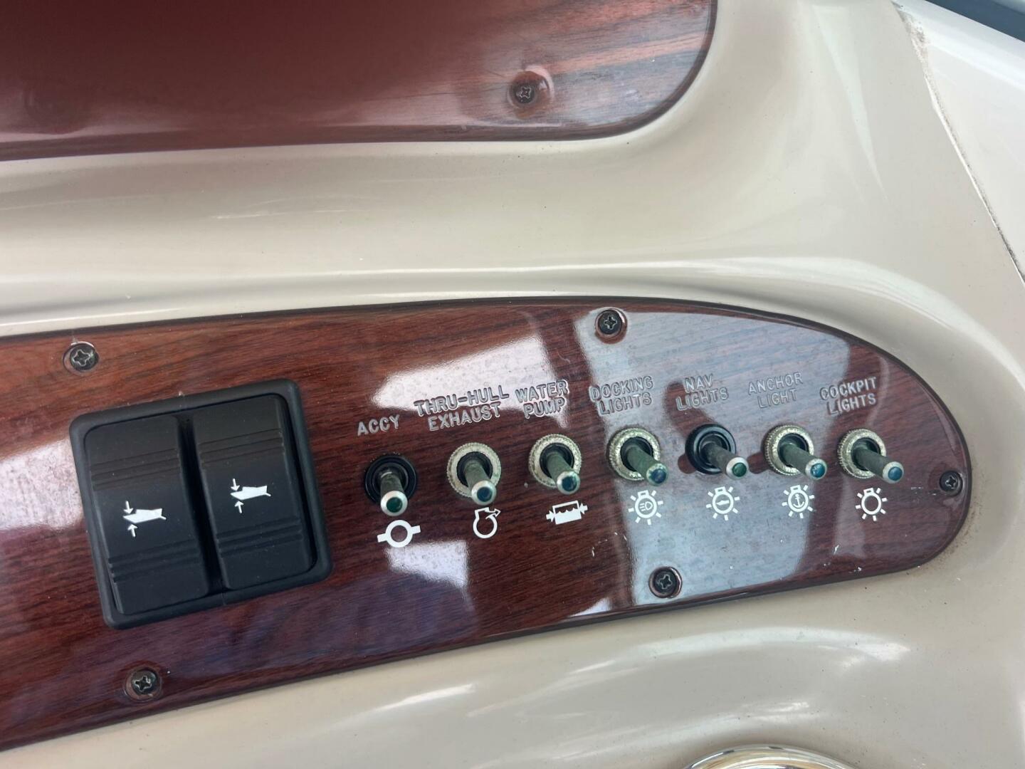 Control panel of a 2007 Sea Ray 240 Sundeck boat with labeled switches.