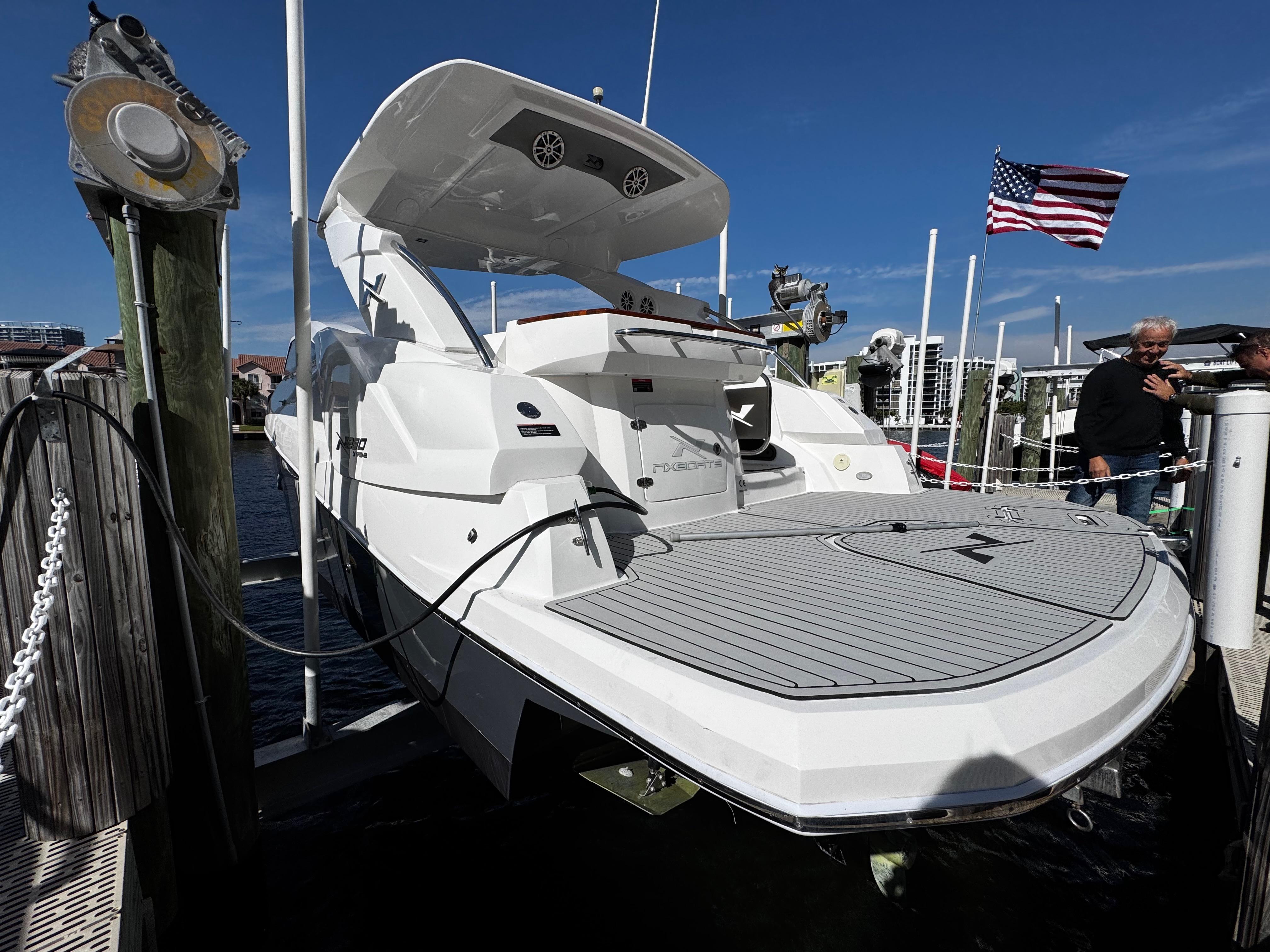 2024 NX Boats 280 Xtreme docked, showcasing sleek design and spacious deck.