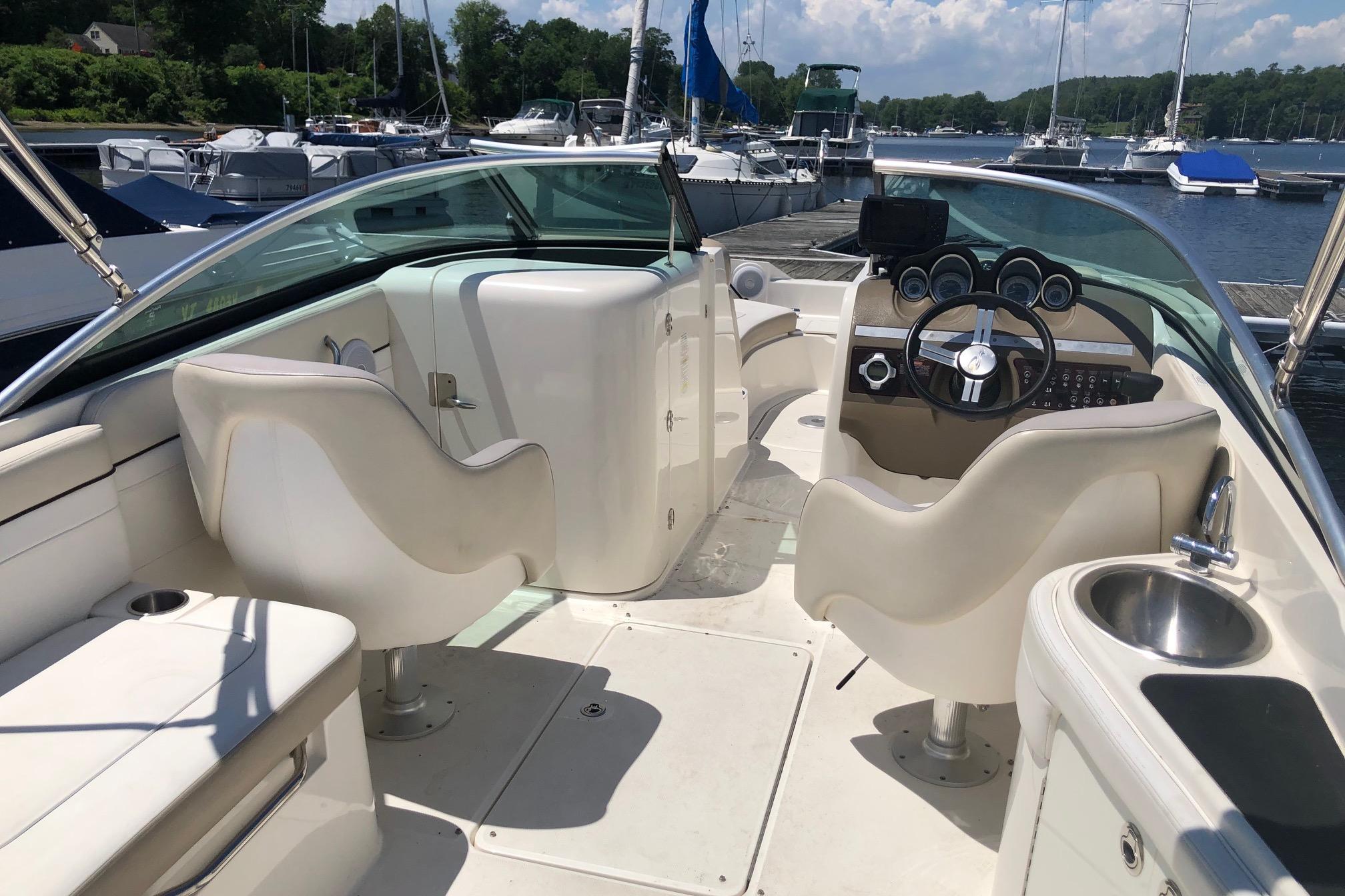 2013 Sea Ray 260 Sundeck interior with helm, seating, and marina view.