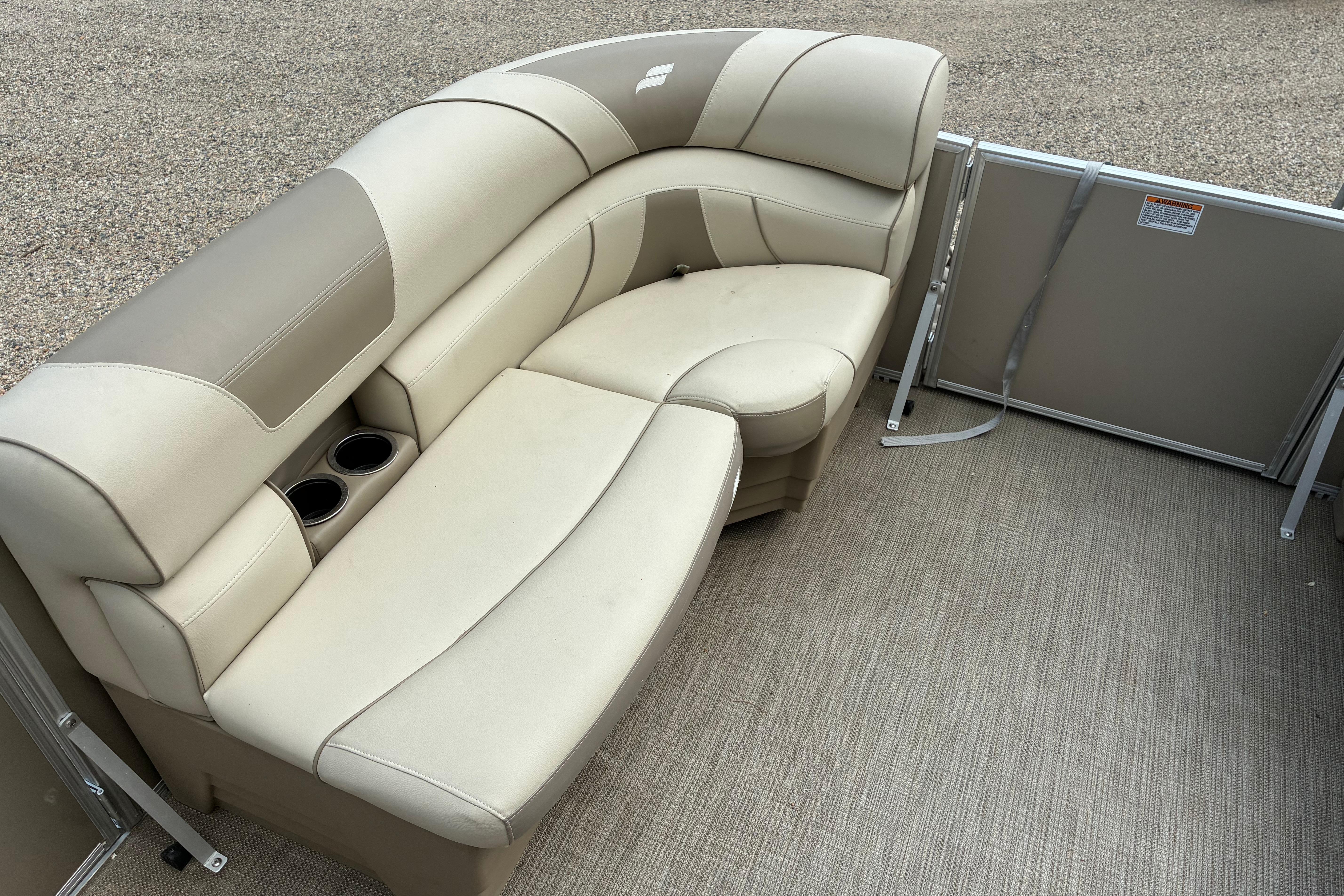 2020 Starcraft EX 20 C pontoon boat interior with beige seating and cup holders.