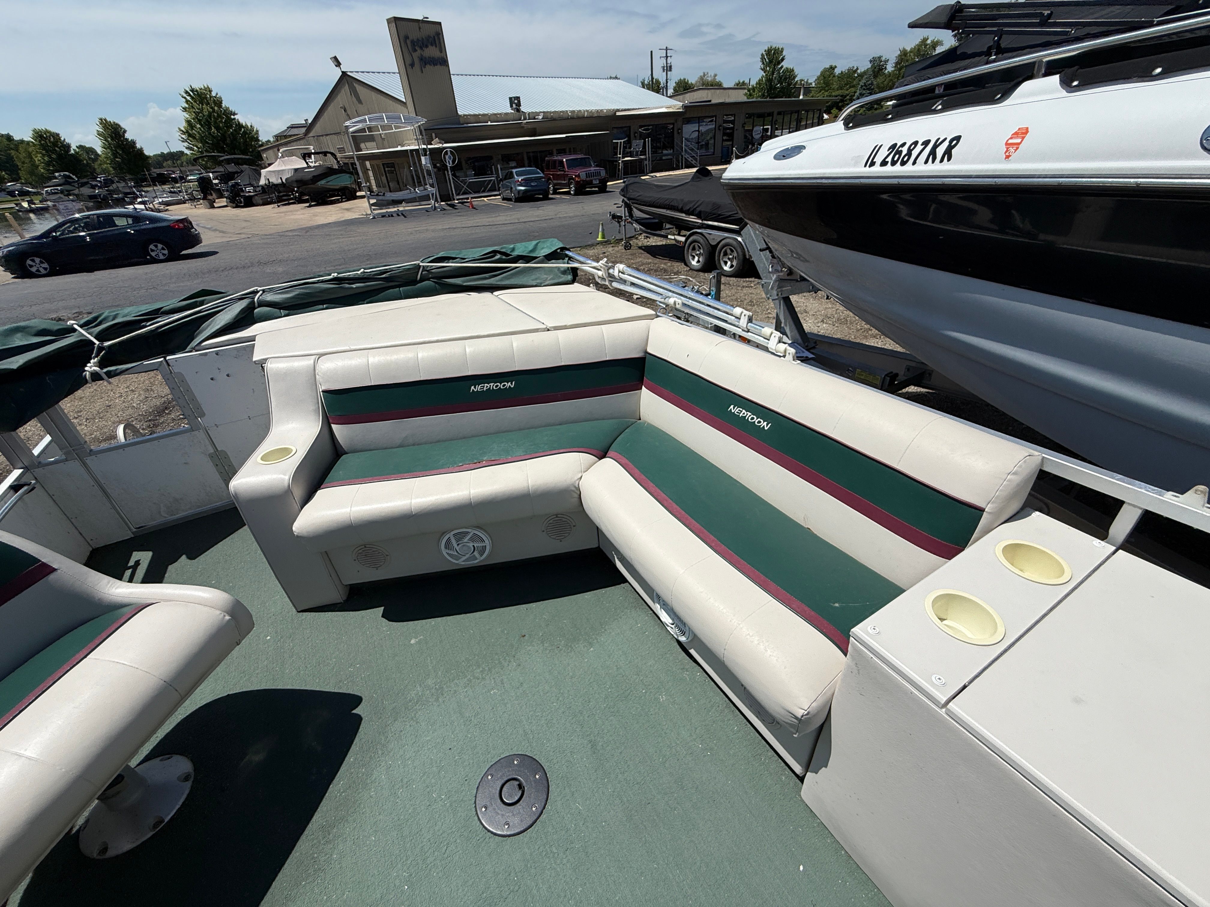 Interior of a 1999 JC Mfg. 24 pontoon boat with seating area.