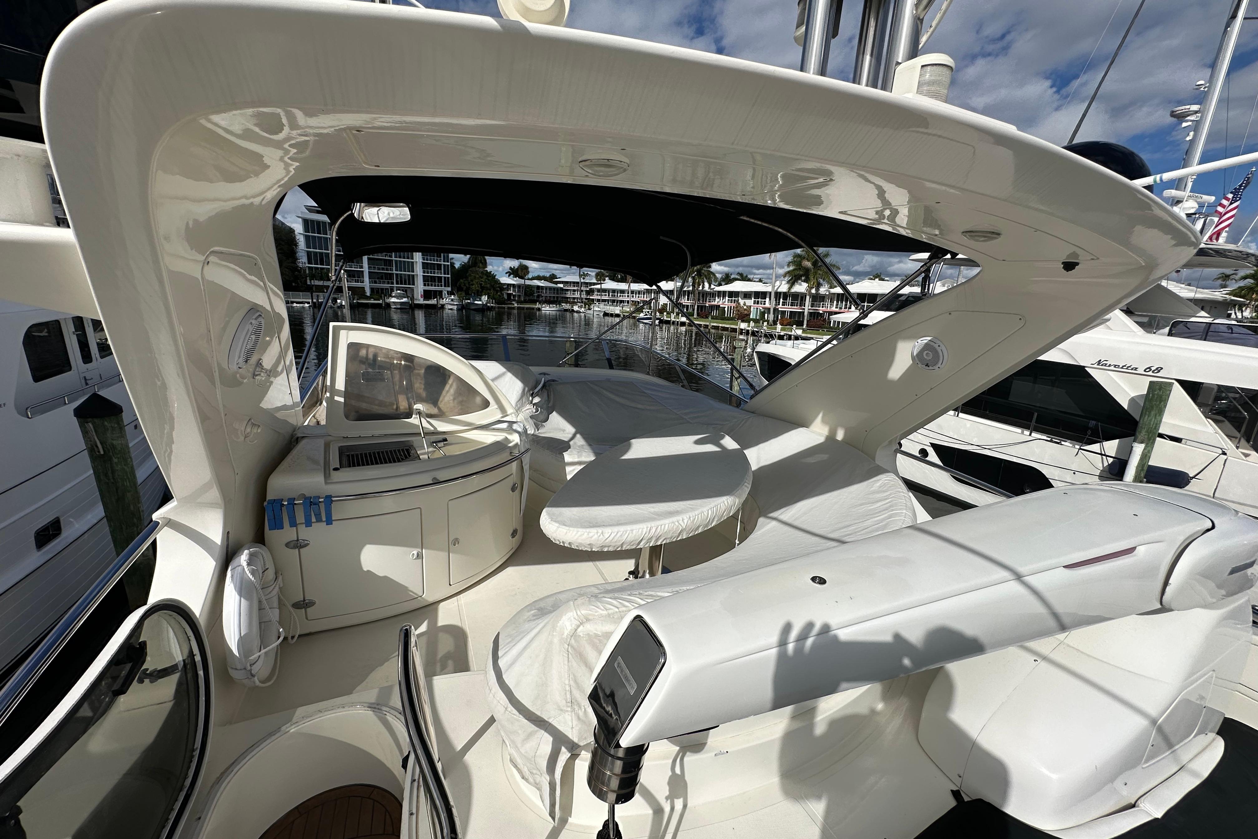 2004 Azimut 55E yacht deck with seating and marina view.