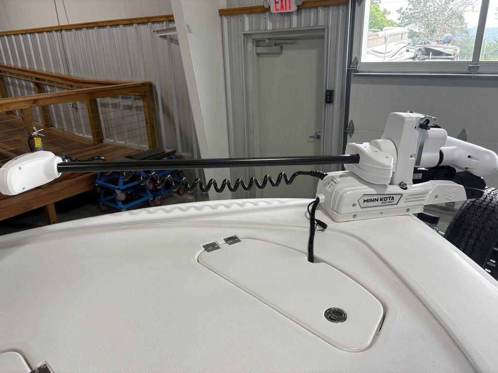 2026 Tidewater 2110 BM boat with Minn Kota trolling motor in a garage setting.