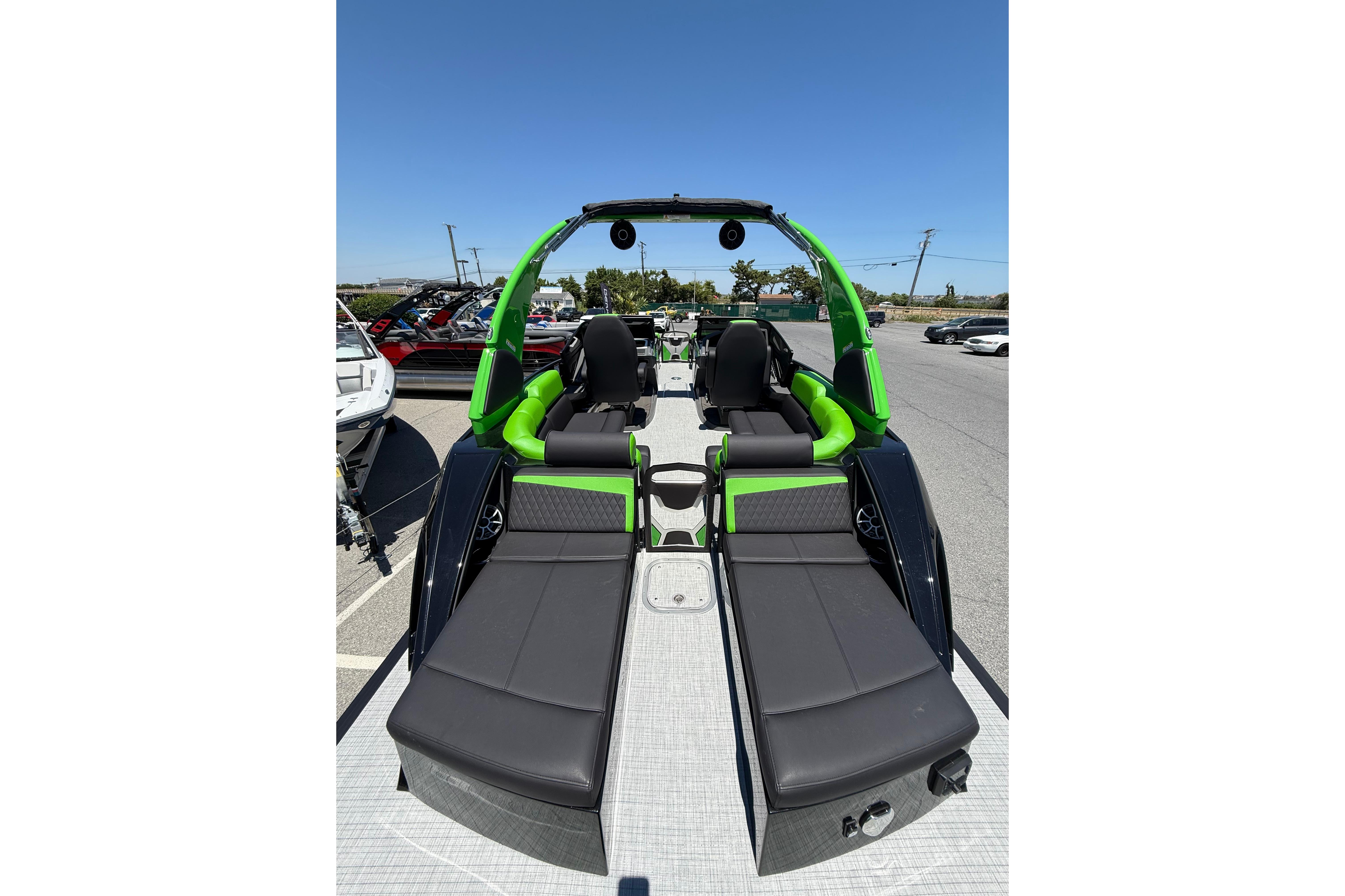 2026 Berkshire Sport SLX9 DC boat with sleek black and green seating, parked outdoors.