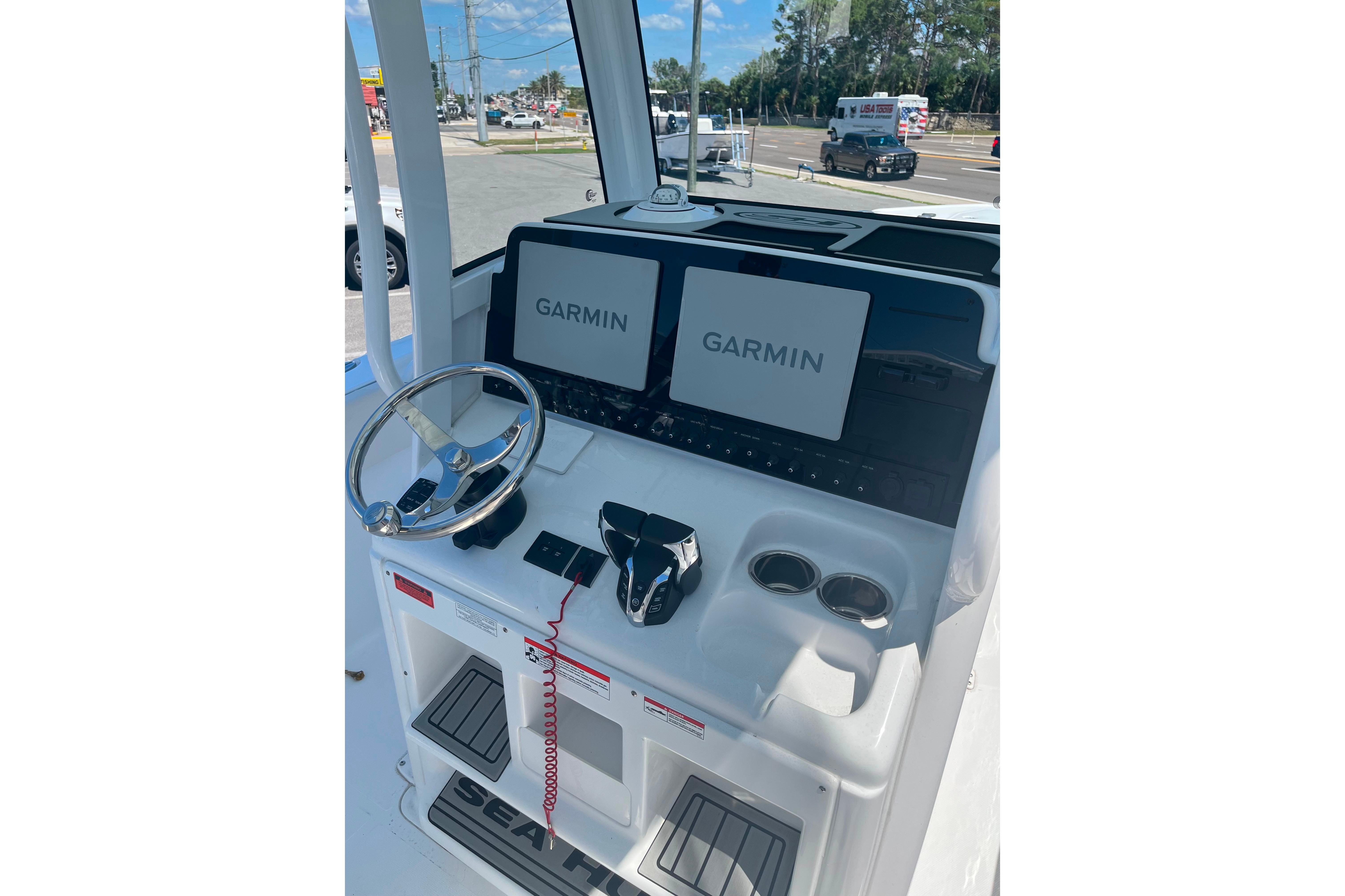 2026 Sea Hunt Ultra 265 SE boat dashboard with Garmin displays and steering wheel.