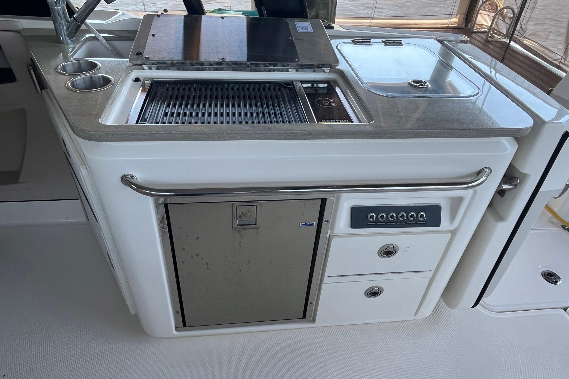 2022 Boston Whaler 320 Vantage boat kitchen with grill and sink.