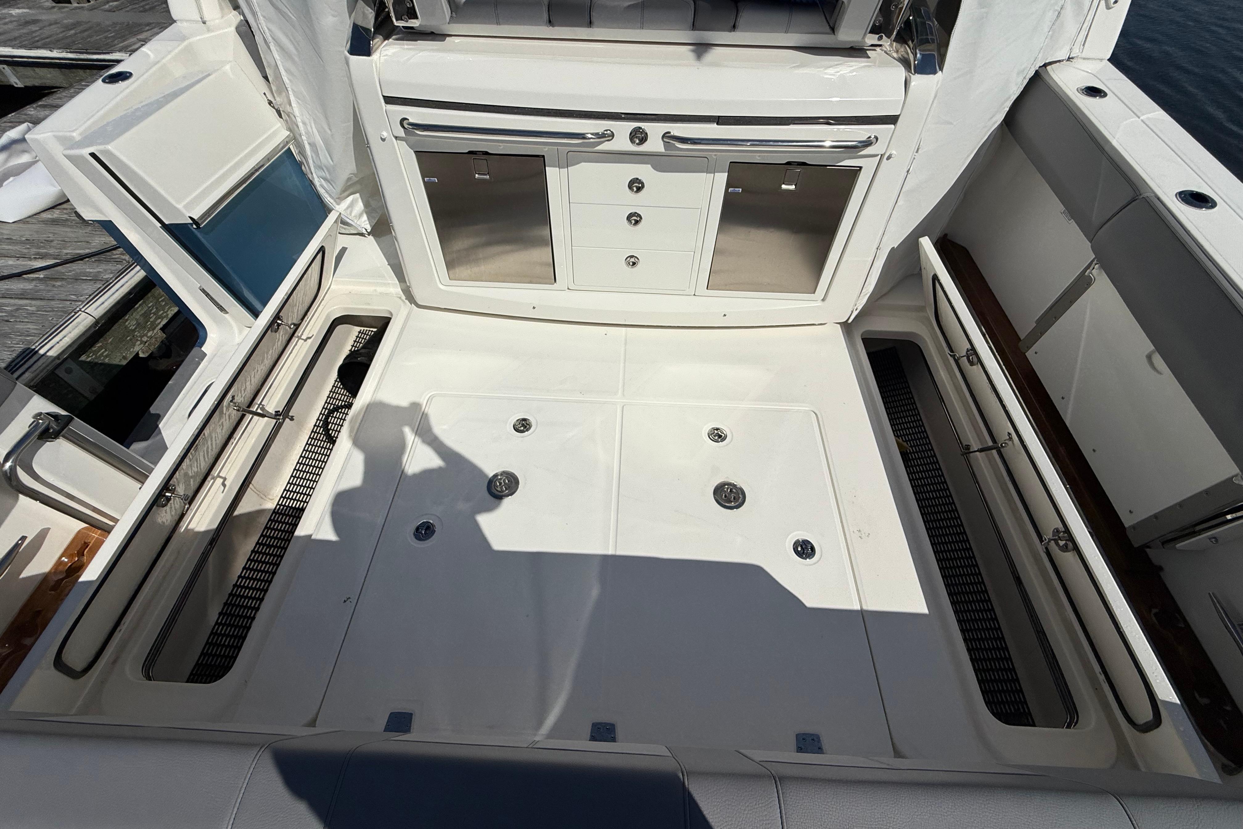 2024 Boston Whaler 420 Outrage deck with storage compartments and cabinetry.