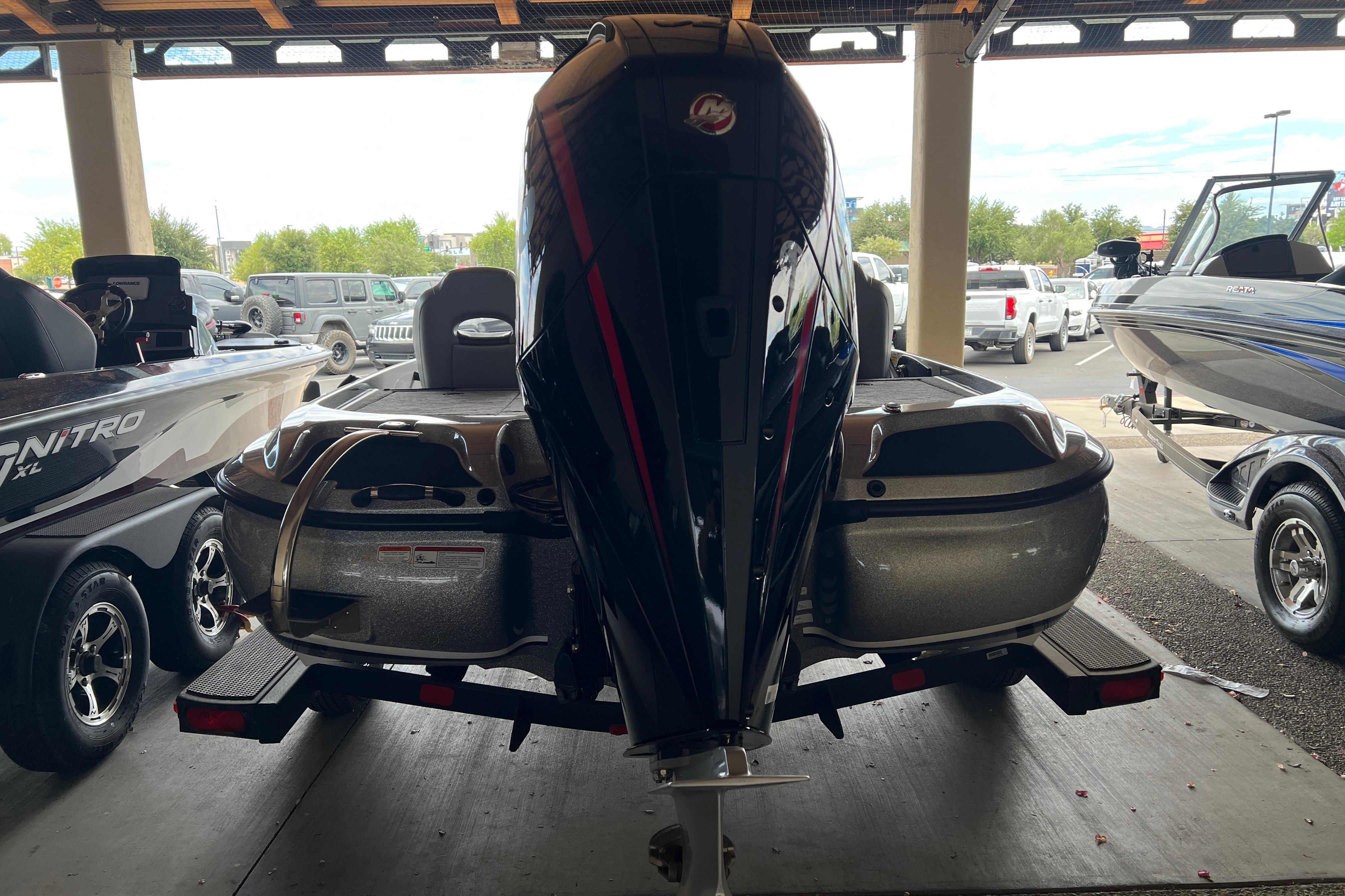 2026 Nitro Z19 XL Pro boat in showroom, rear view with motor and trailer.