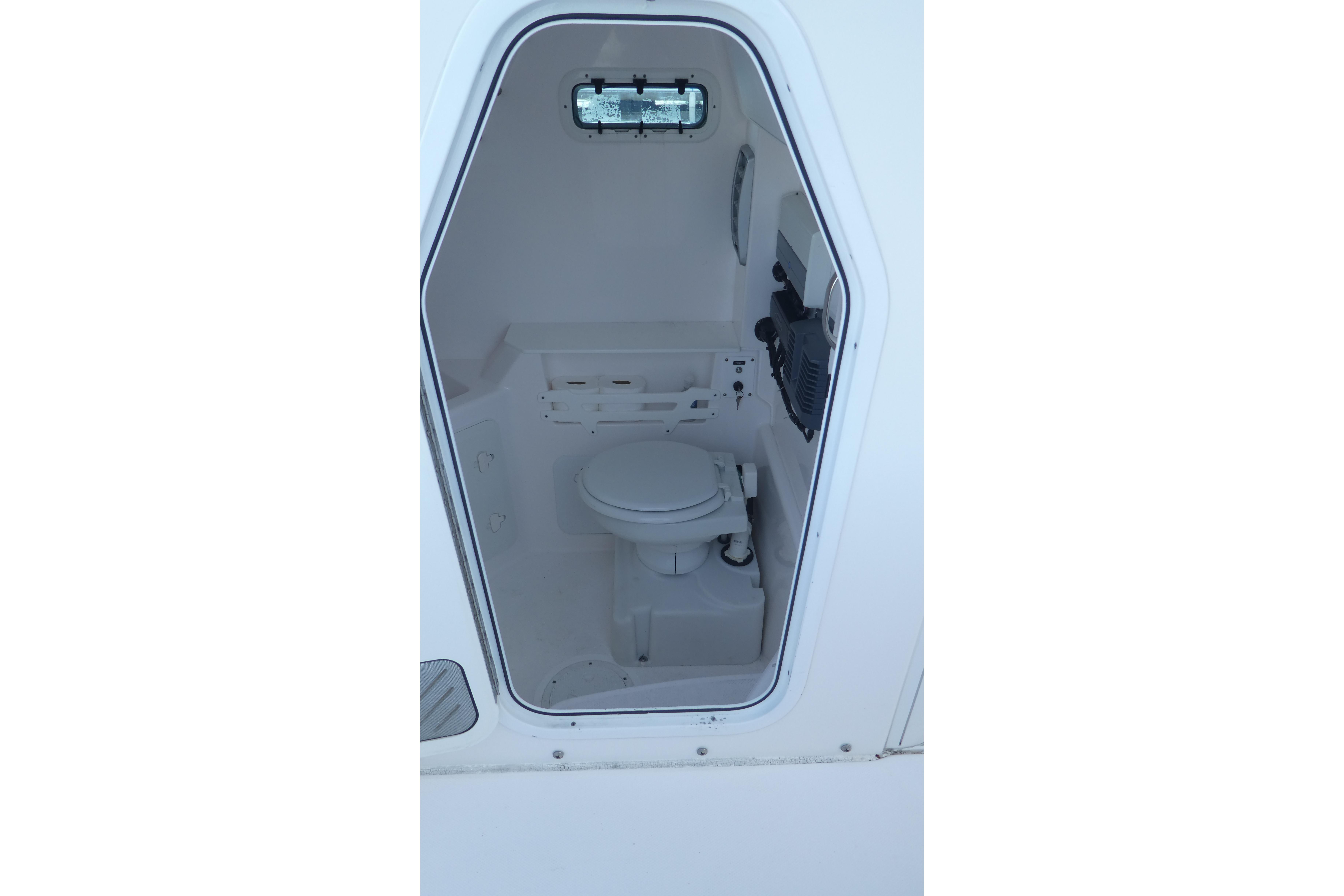 Interior view of 2015 Everglades 295 Center Console boat's compact marine toilet.