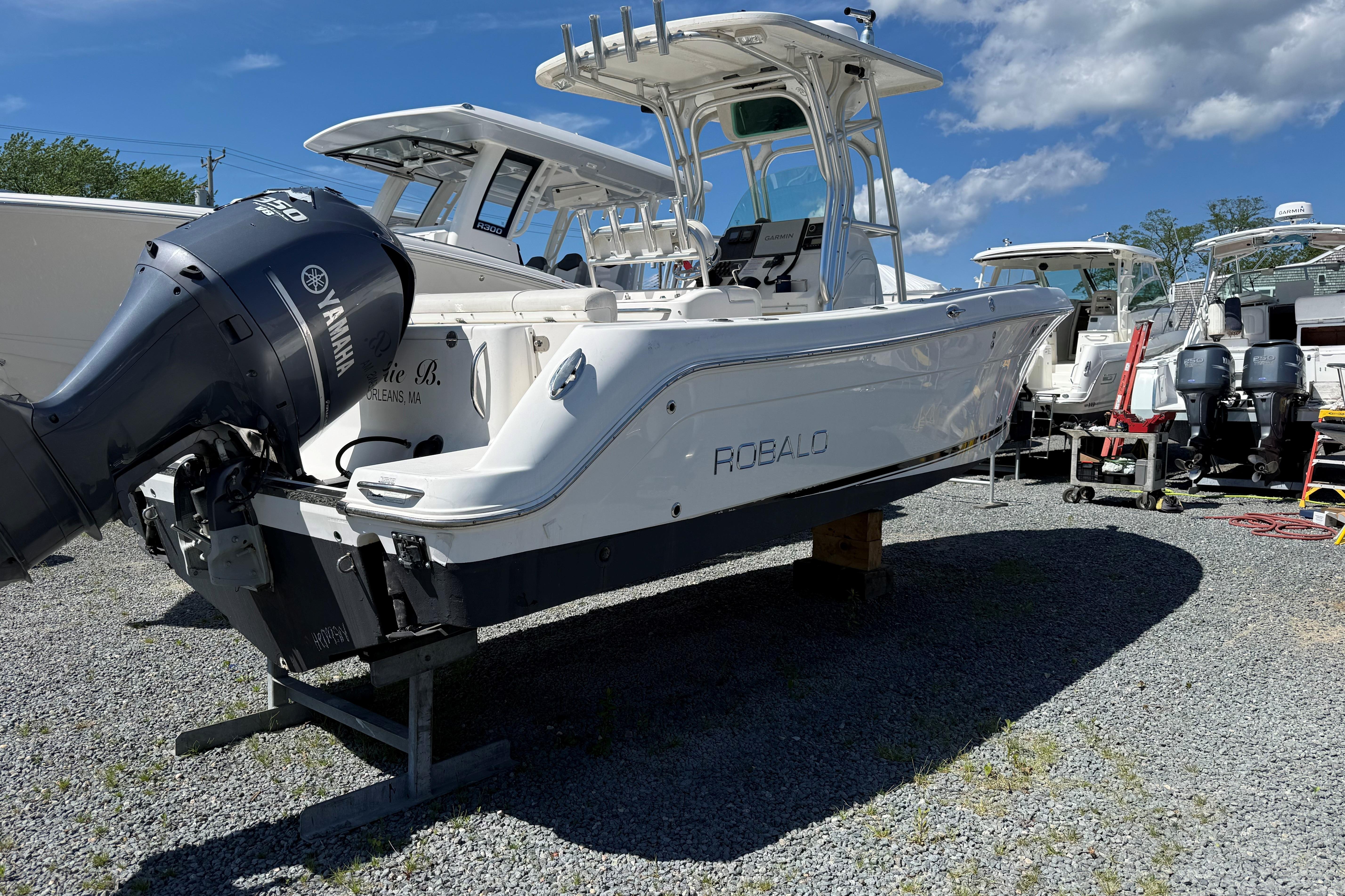 2009 Robalo R240 Center Console boat with Yamaha engine on gravel lot.