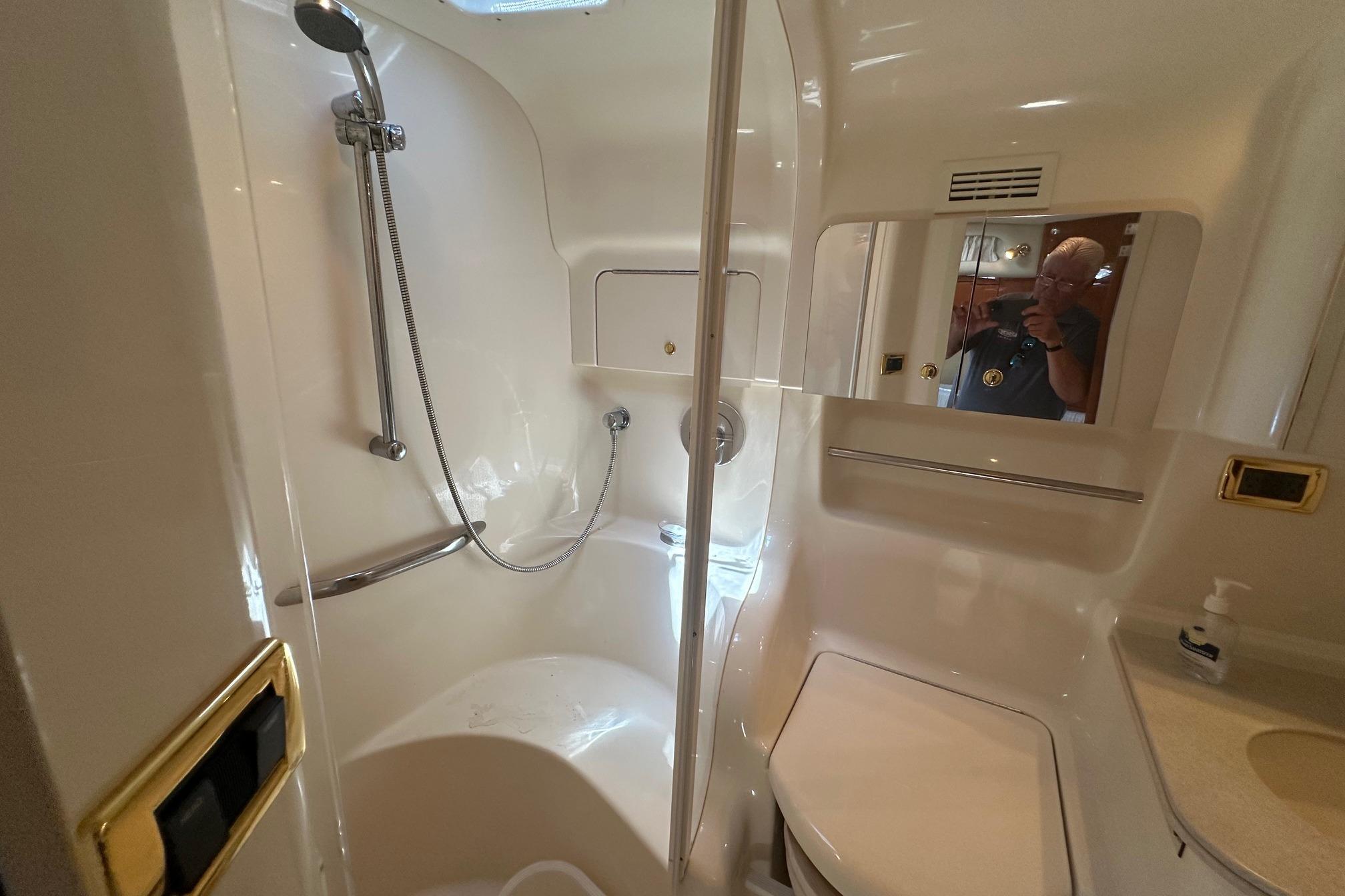 Bathroom interior of 2001 Sea Ray 410 Sundancer yacht, featuring shower and vanity.