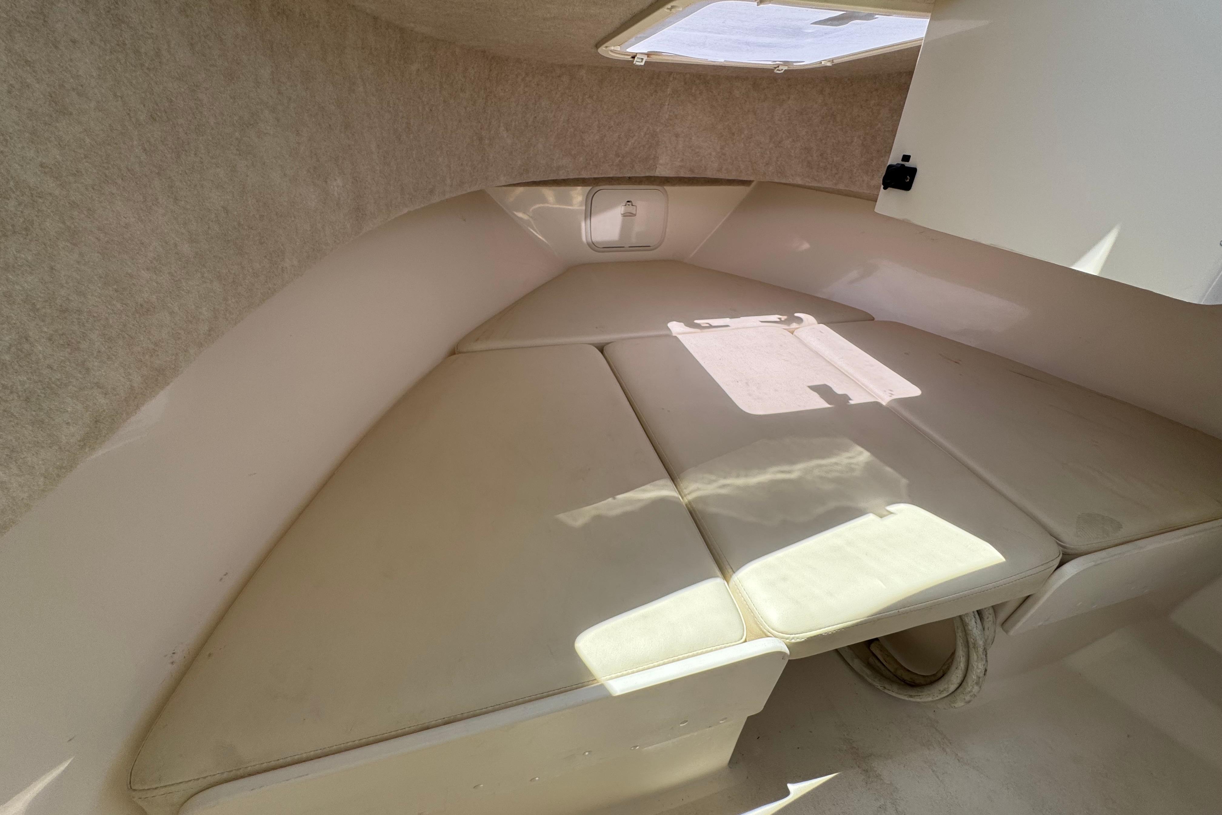2017 Defiance Admiral 220 EX cabin interior with cushioned seating and overhead hatch.