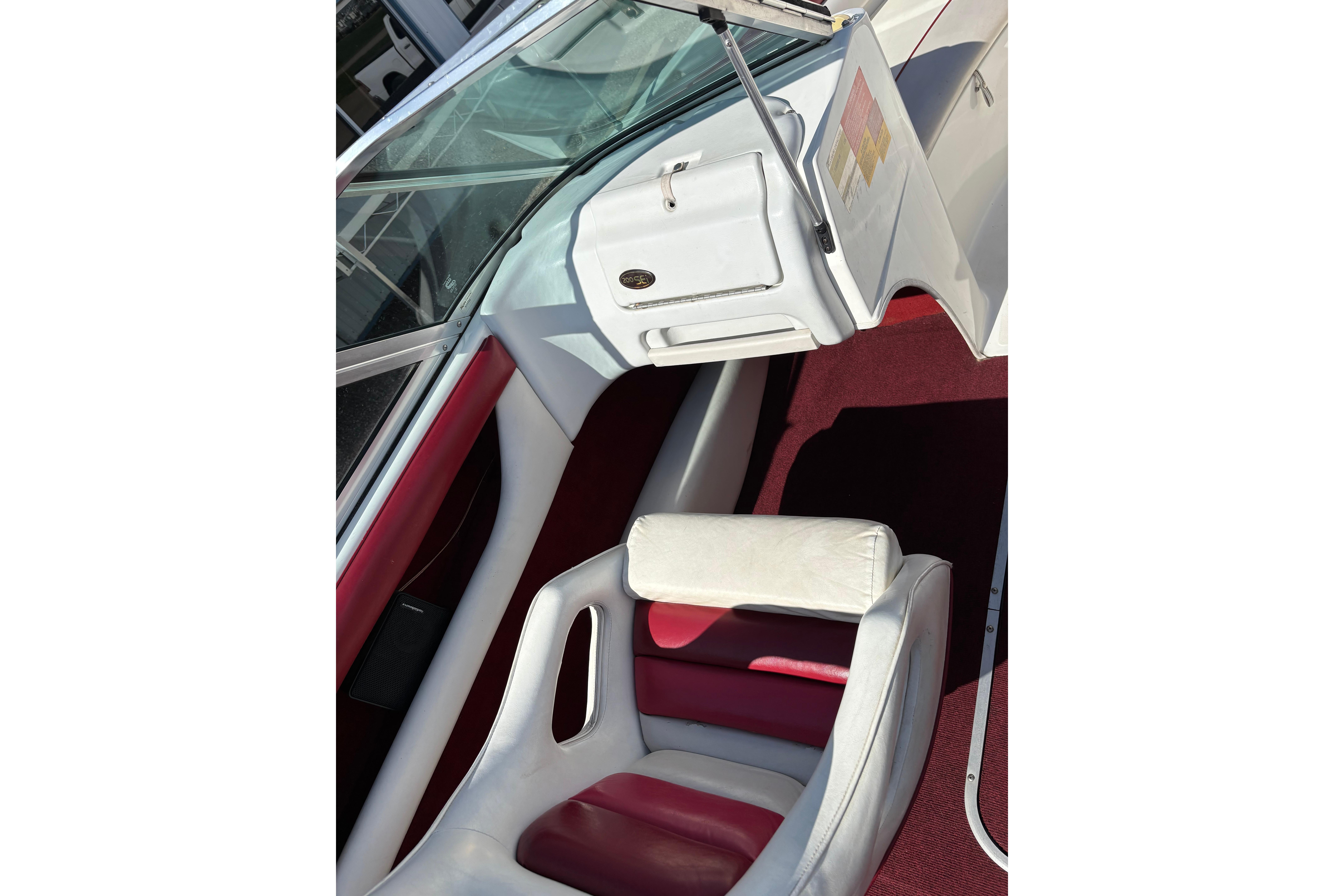 Interior of a 1993 Larson SEi 200 Cuddy I/O boat with red and white seating.