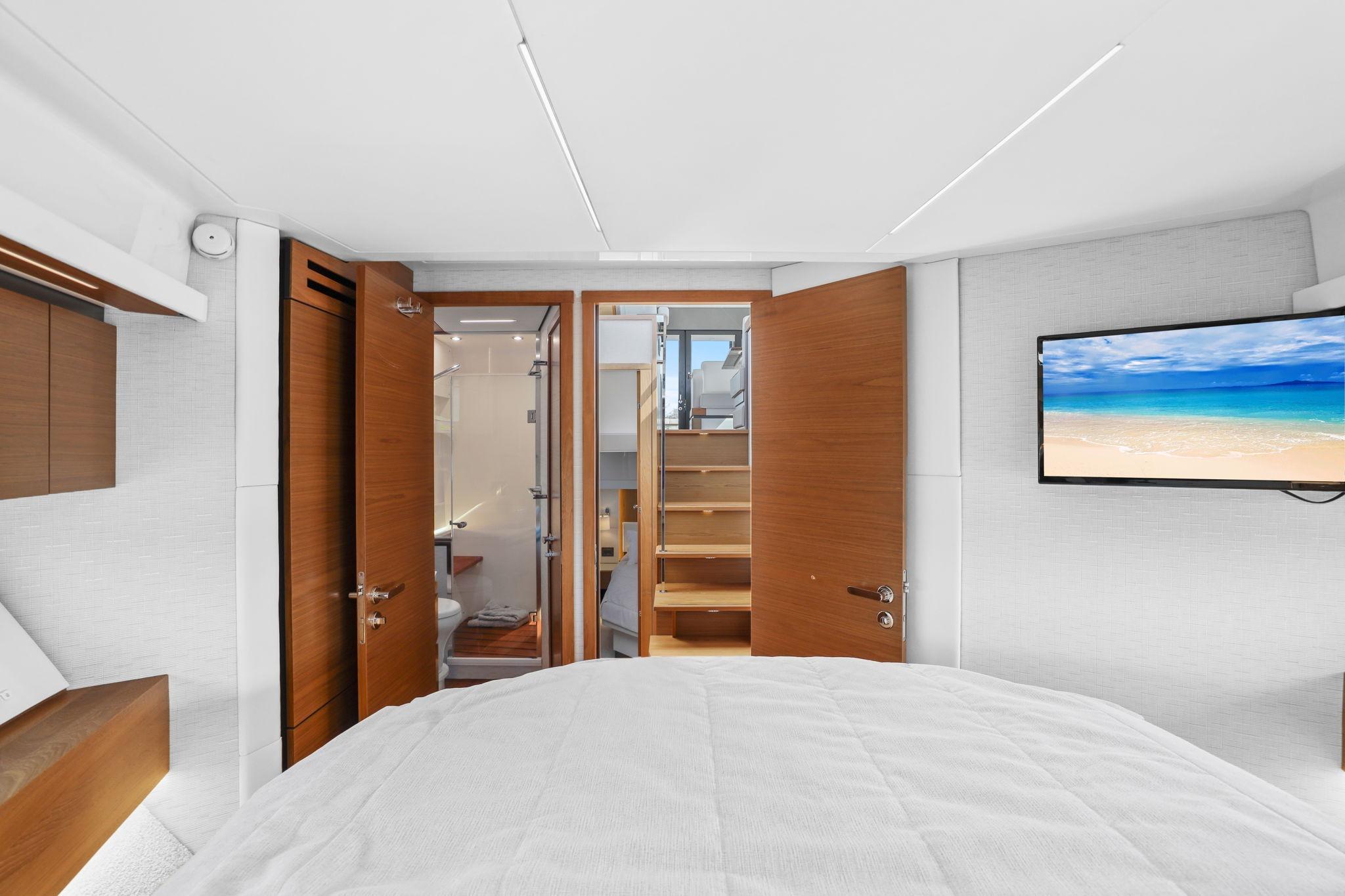 Luxurious interior of 2023 Tiara Yachts C49 Coupe with modern design and beach view on TV.
