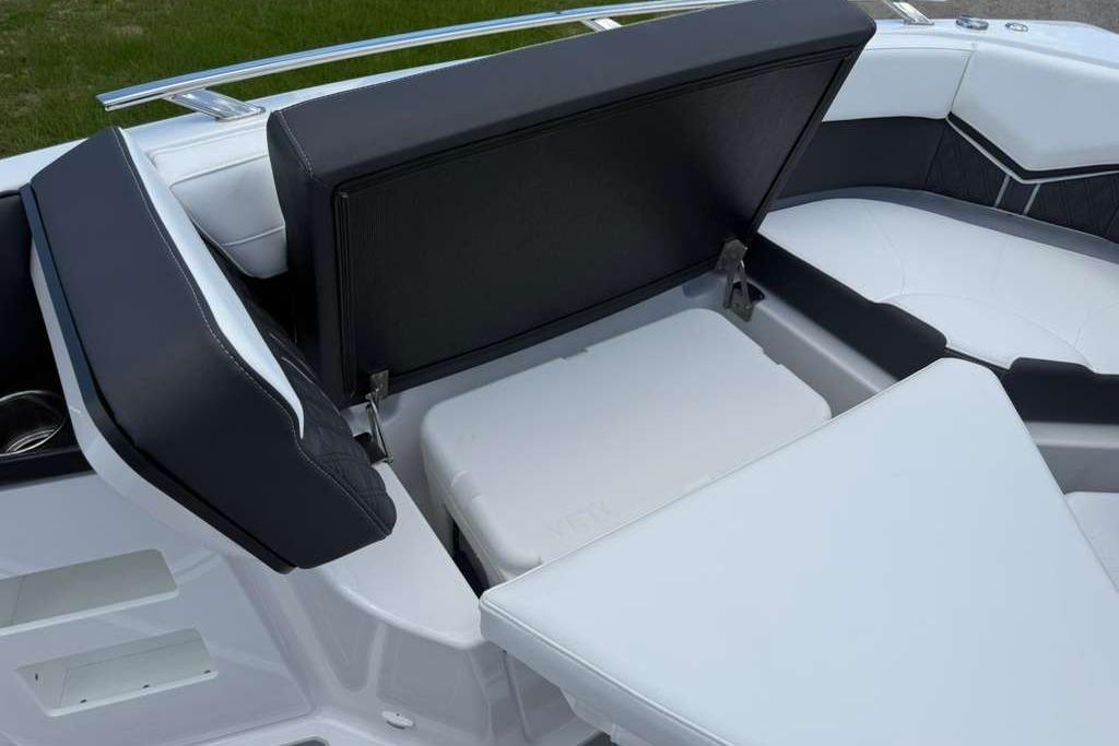 2026 Monterey Elite 30 OB boat interior with open storage compartment and cushioned seating.