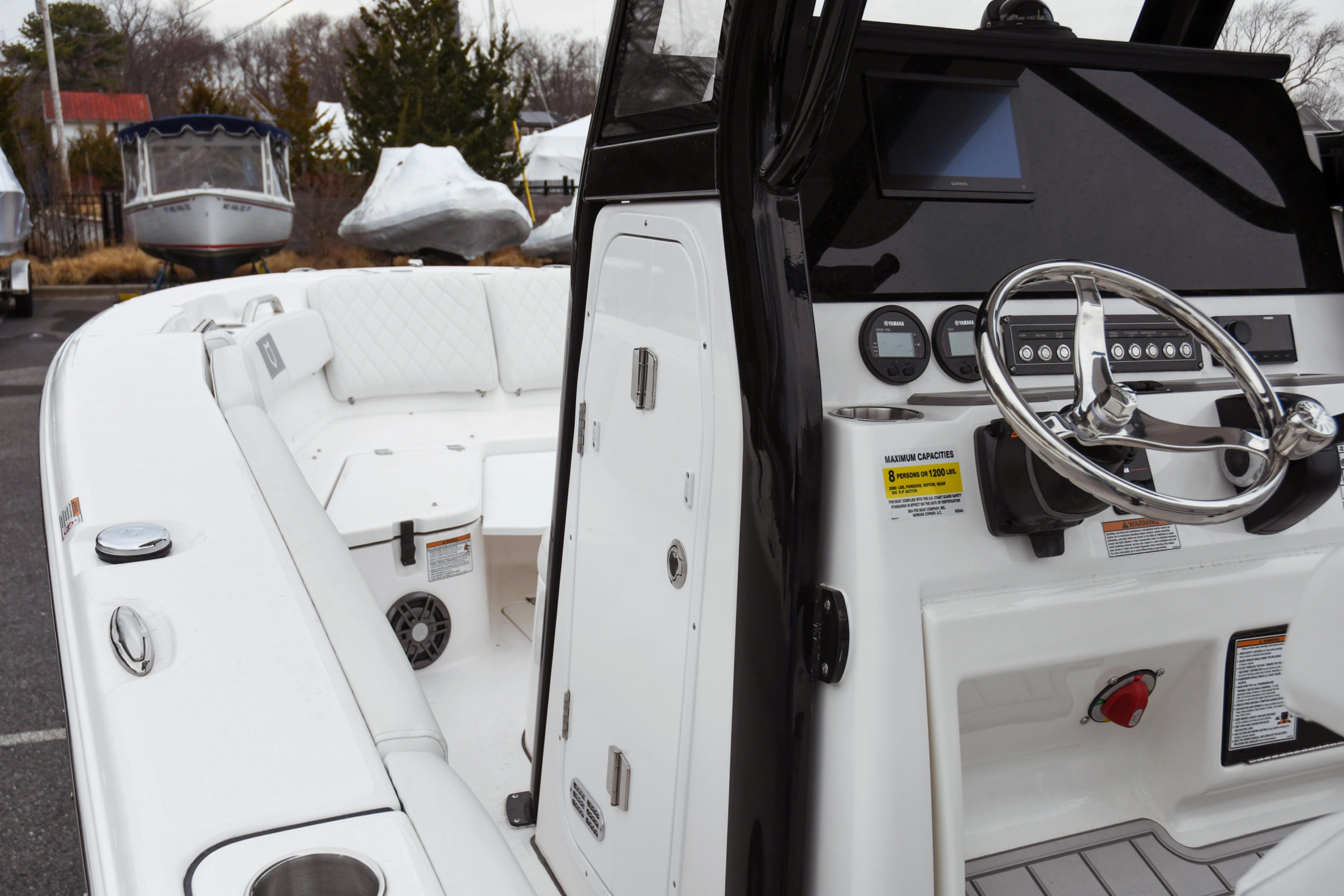2026 Sea Fox 228 Commander boat interior with steering wheel and seating area.
