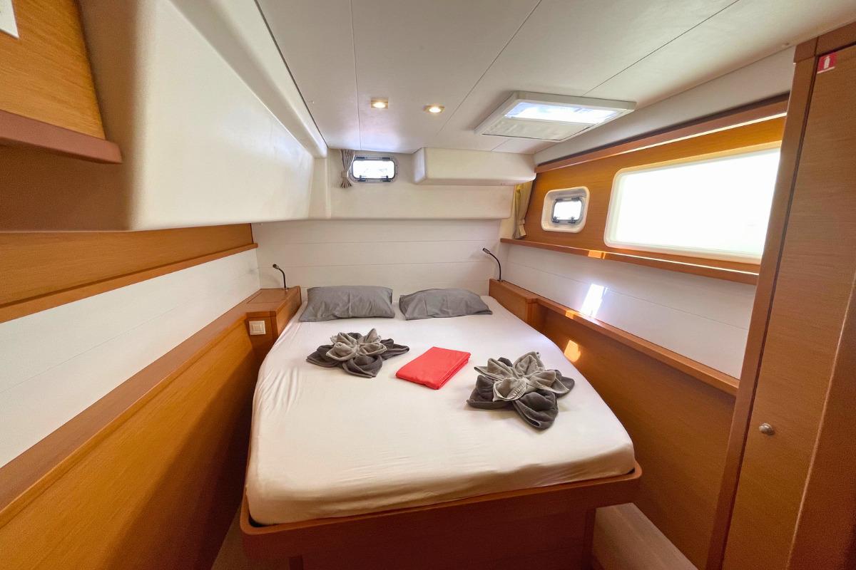 Luxurious cabin interior of 2018 Lagoon 450 F catamaran with cozy bed and elegant decor.