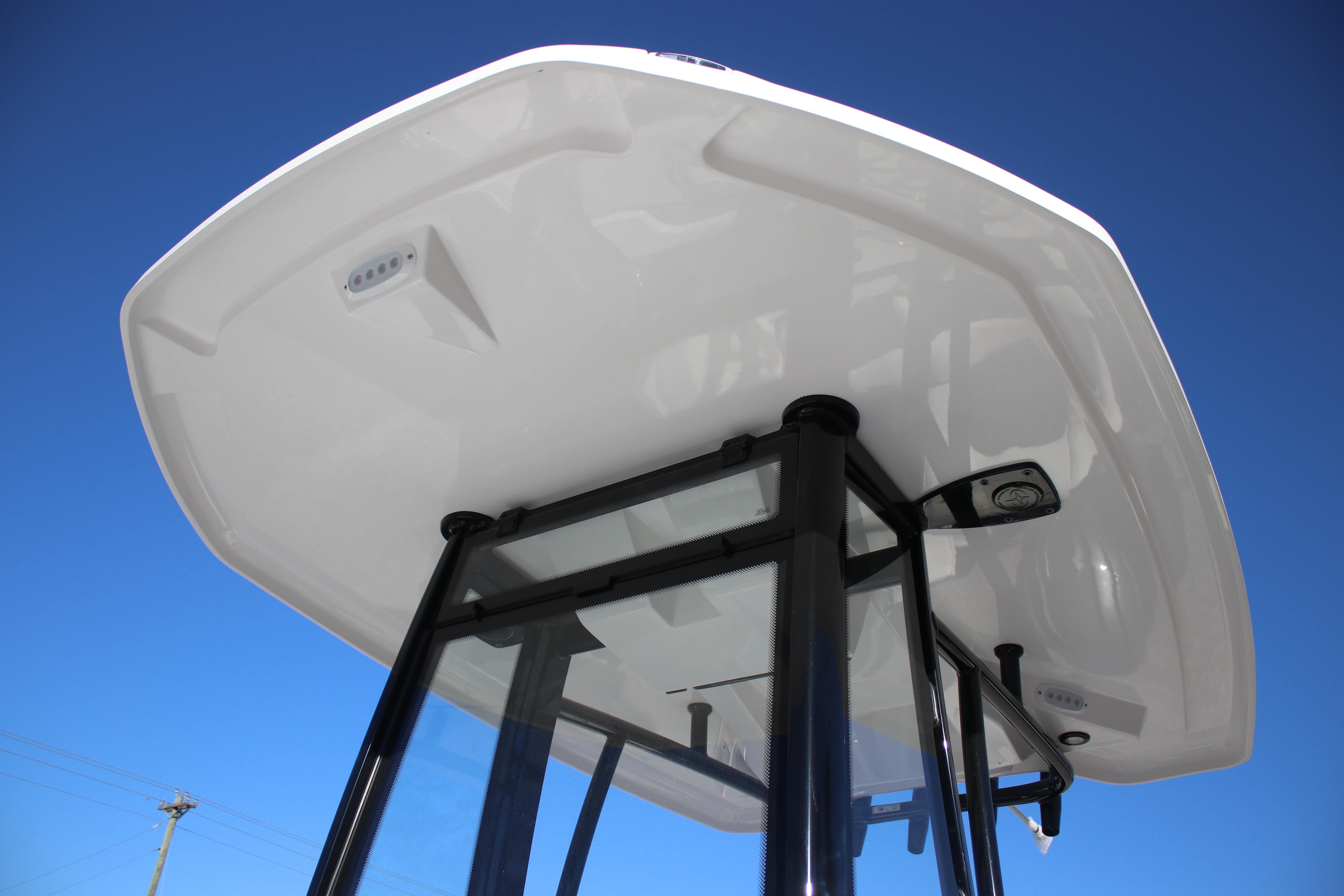 Tidewater 2210 Carolina Bay 2026 boat T-top against clear blue sky.