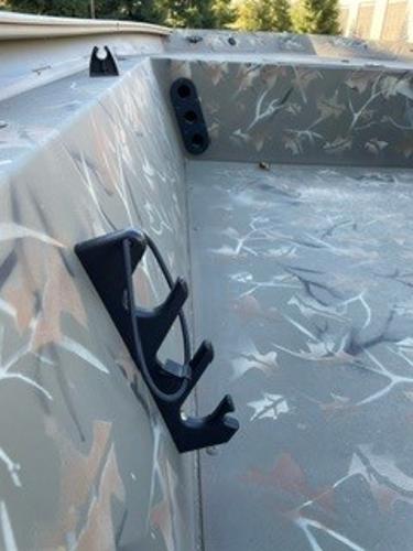 2024 Tracker Grizzly 1754 SC boat interior with camouflage design and rod holders.