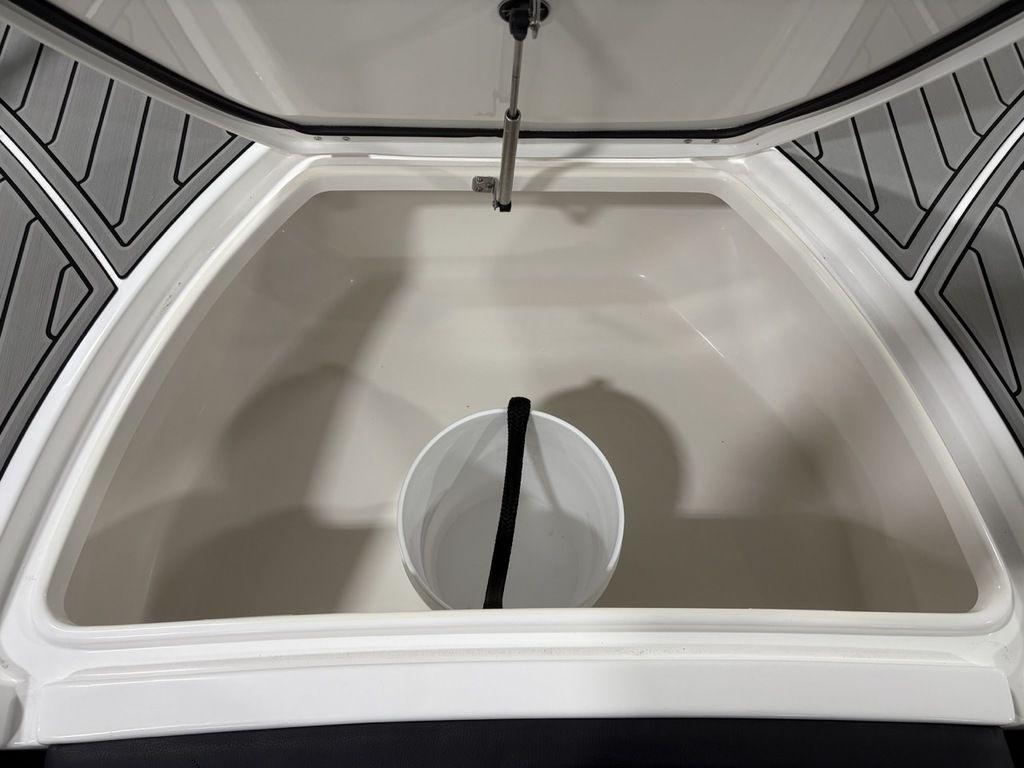 Open storage compartment in 2026 Tidewater 2700 CB boat with a white bucket inside.