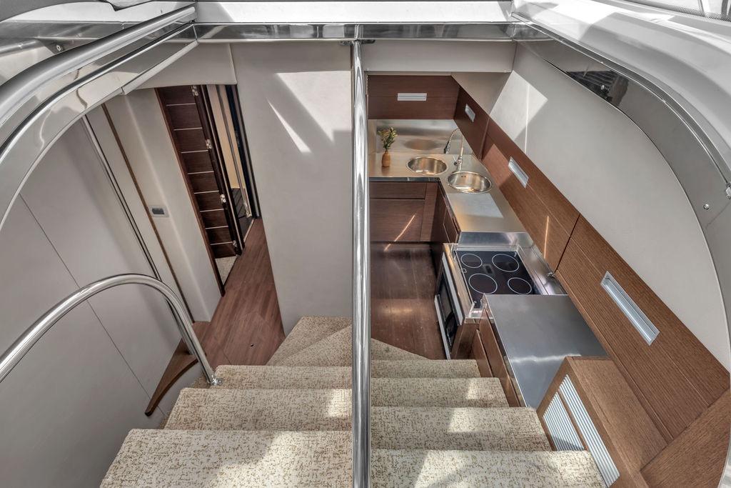 Interior view of 2006 Azimut 68S yacht, featuring modern kitchen and staircase.
