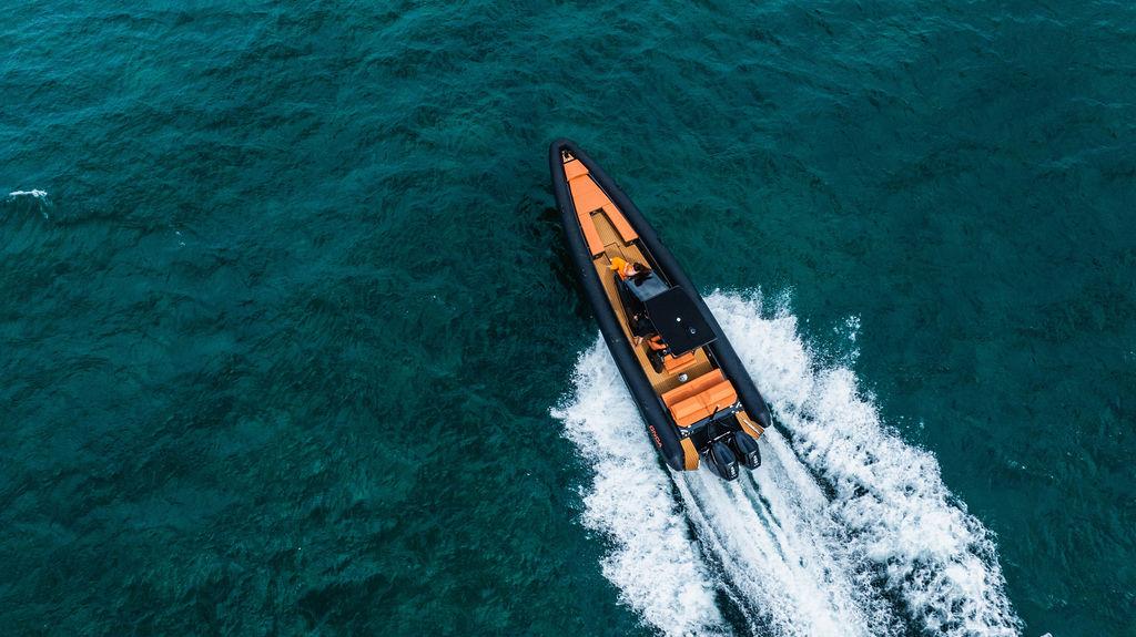 Aerial view of 2025 Onda Magna boat cruising on clear blue water.