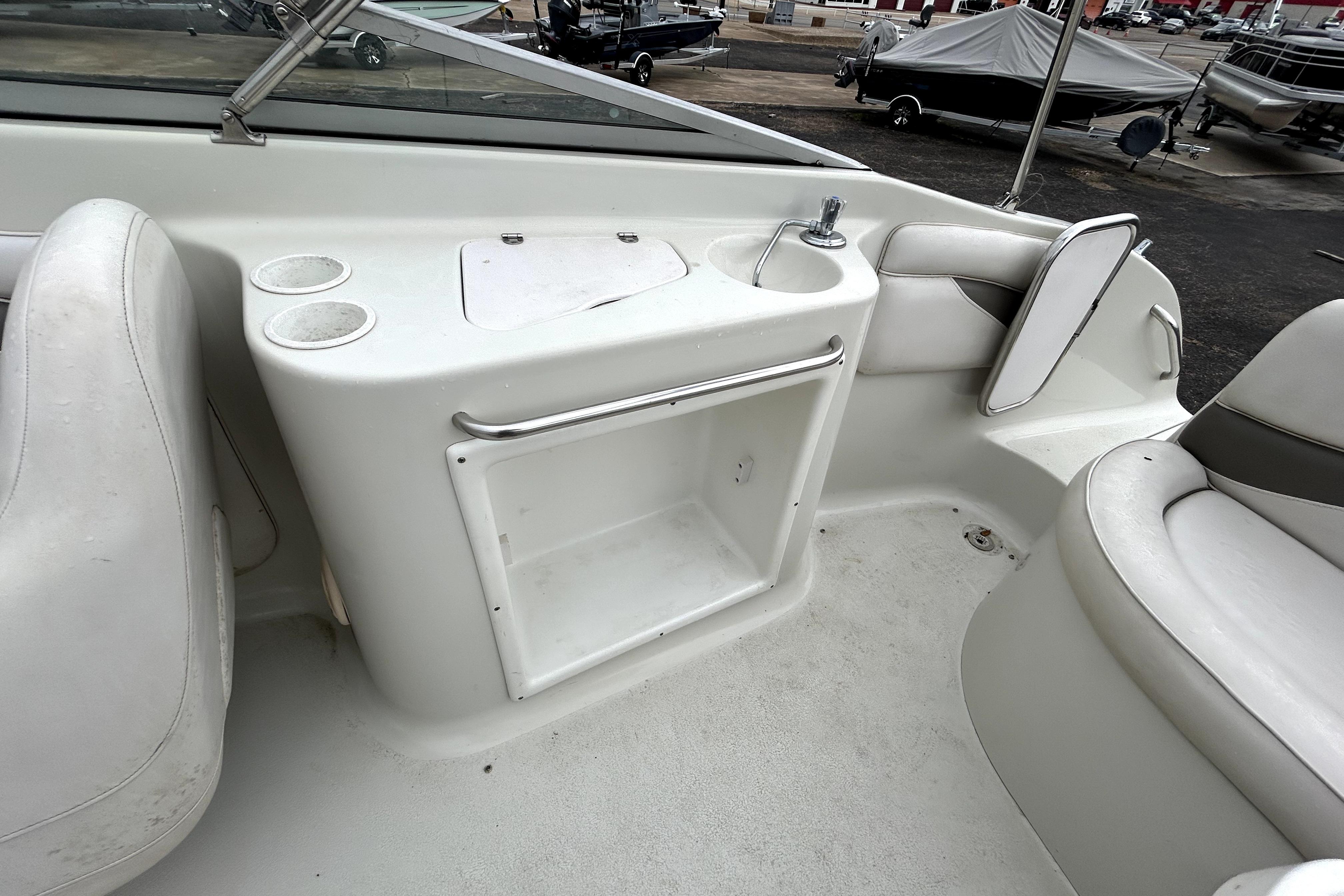 Interior of 2001 Crownline 239 DB boat with seating and storage area.